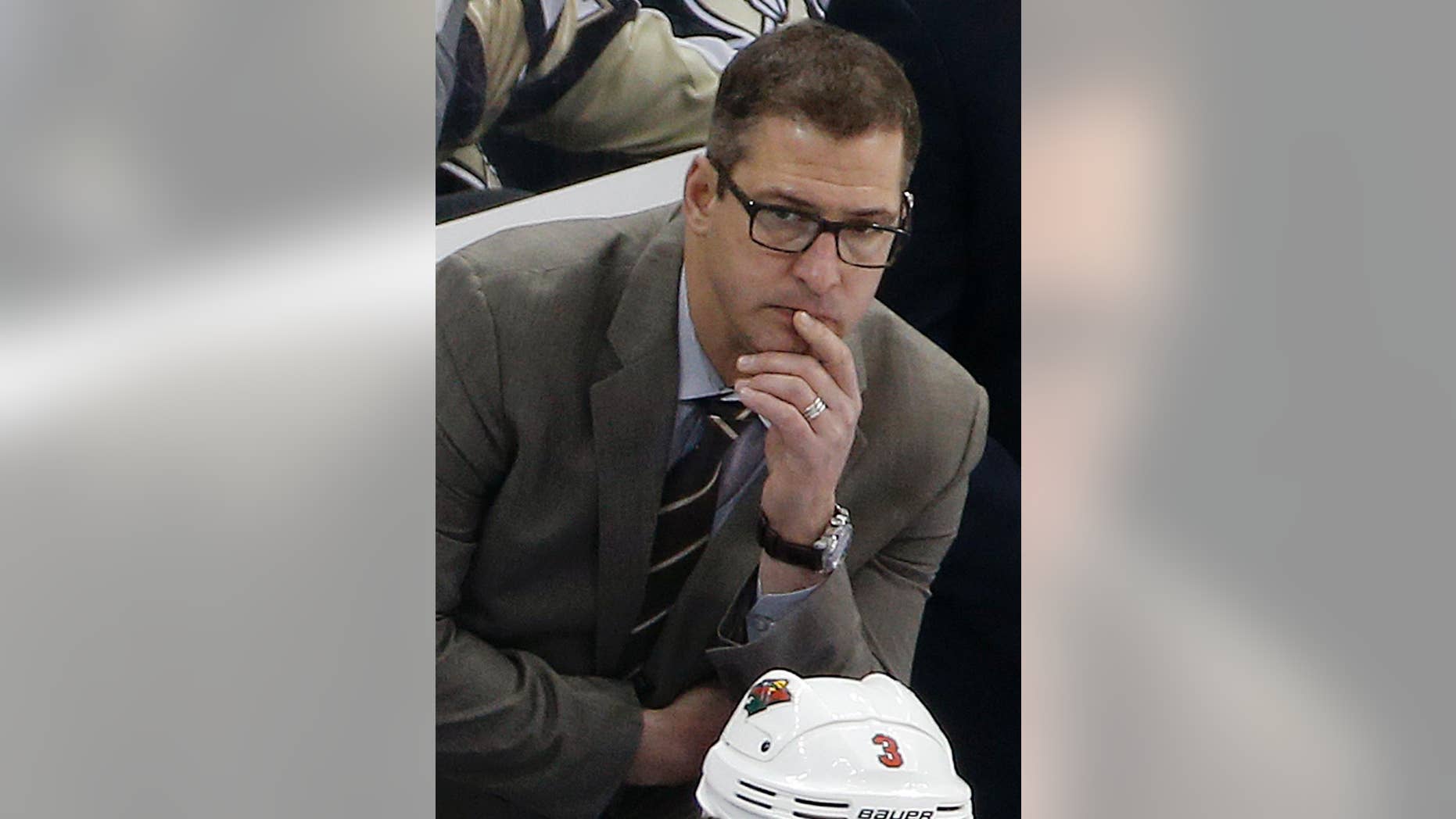 FILE- In this Jan. 13, 2015, file photo, Minnesota Wild assistant coach Darryl Sydor, shown during an NHL hockey game in Pittsburgh, has been charged with drunken driving after being arrested while taking his 12-year-old son to a hockey game. He has been an assistant coach for the past four seasons and also played 18 seasons in the NHL. (AP Photo/Gene J. Puskar,File)