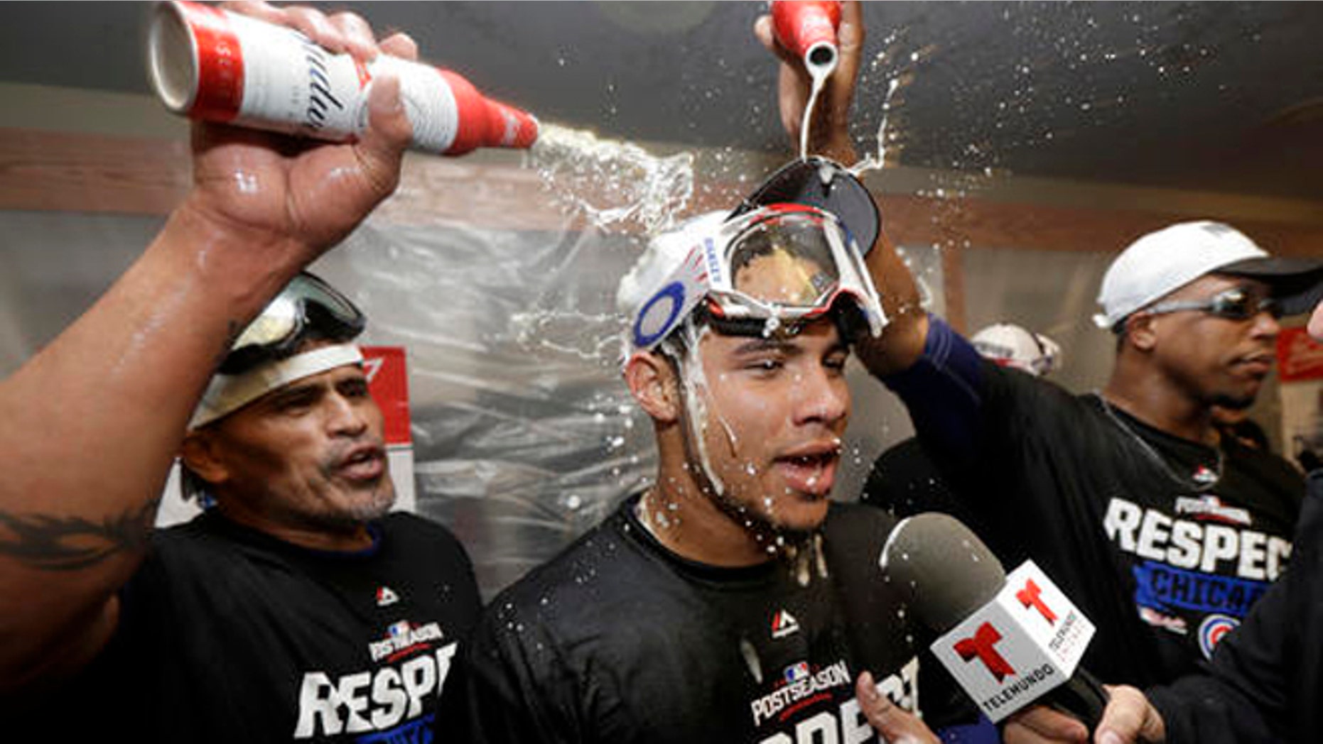 Chicago Cubs catcher Willson Contreras, center, has beer poured on him in the locker room after Game 4 of baseball's National League Division Series against the San Francisco Giants in San Francisco, Tuesday, Oct. 11, 2016. The Cubs won 6-5. (AP Photo/Marcio Jose Sanchez)