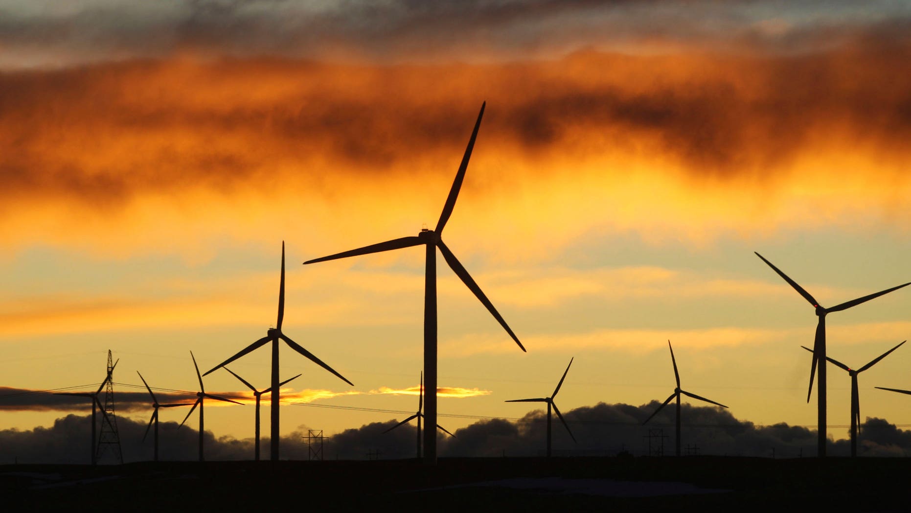 Jan. 19: Clouds turn orange and purple as the sun sets behind the Happy Jack Wind Farm east of Cheyenne, Wyo. Wyoming wind energy developers are holding promotional events in Cheyenne and Casper this week to highlight the positives of the new industry as it works to carve out a place for itself in the state. (AP)
