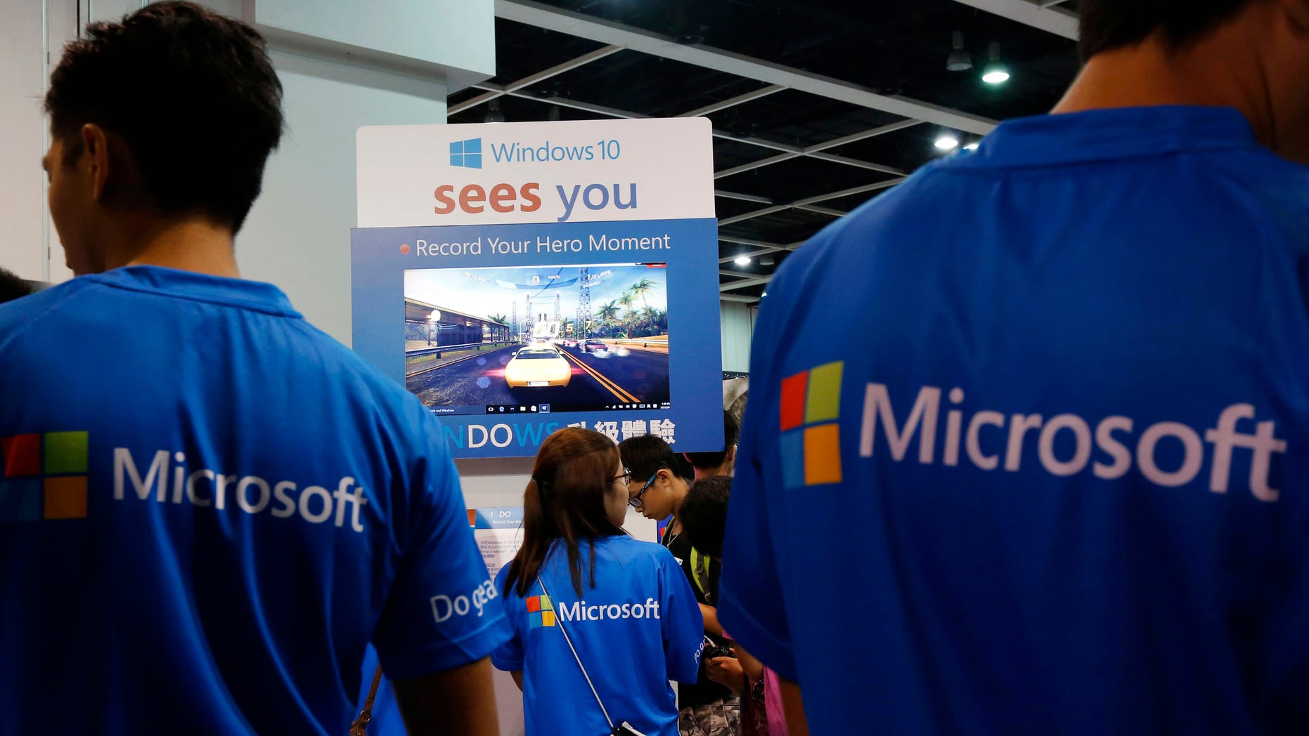 Promotional staff stand at the Microsoft Windows 10 booth two days before its global official launch at the Ani-Com & Games Hong Kong in Hong Kong, China, July 27, 2015.