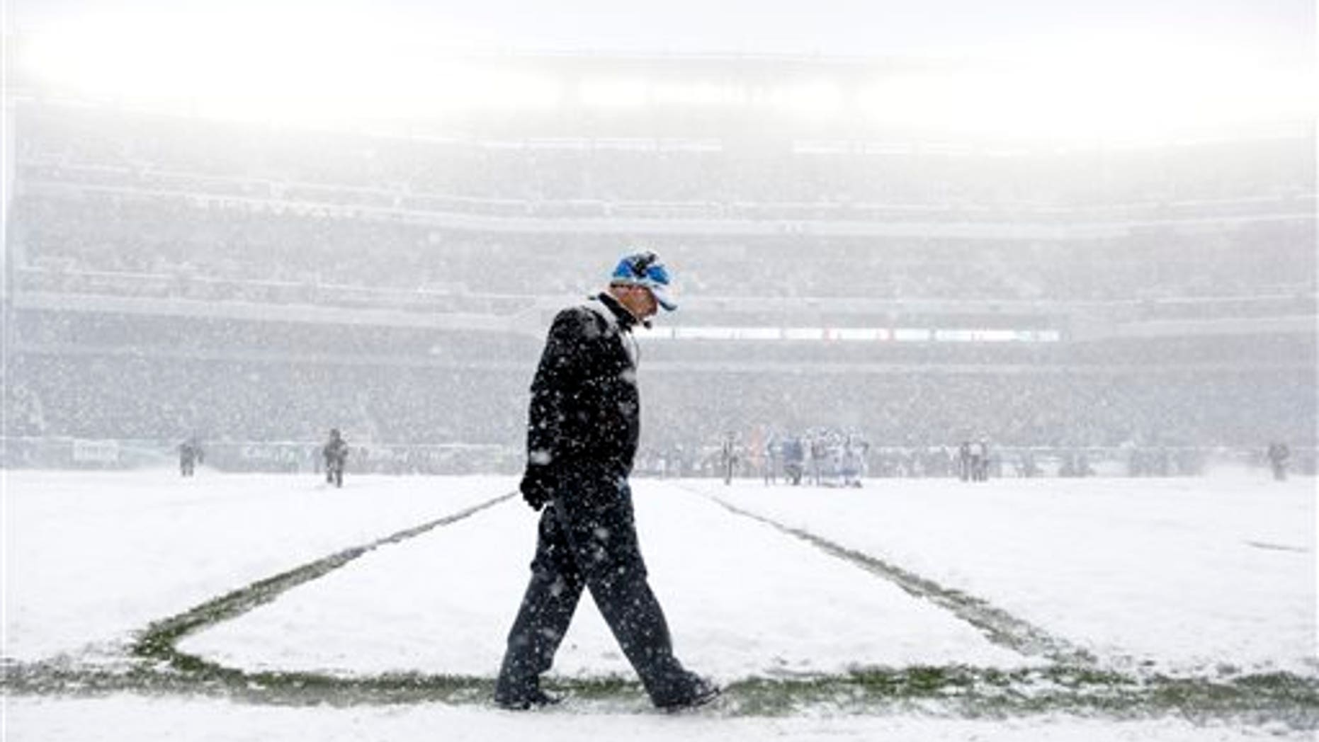 Detroit Lions head coach Jim Schwartz walks the sidelines as snow falls during the first half of an NFL football game against the Philadelphia Eagles, Sunday, Dec. 8, 2013, in Philadelphia. (AP Photo/Matt Rourke)