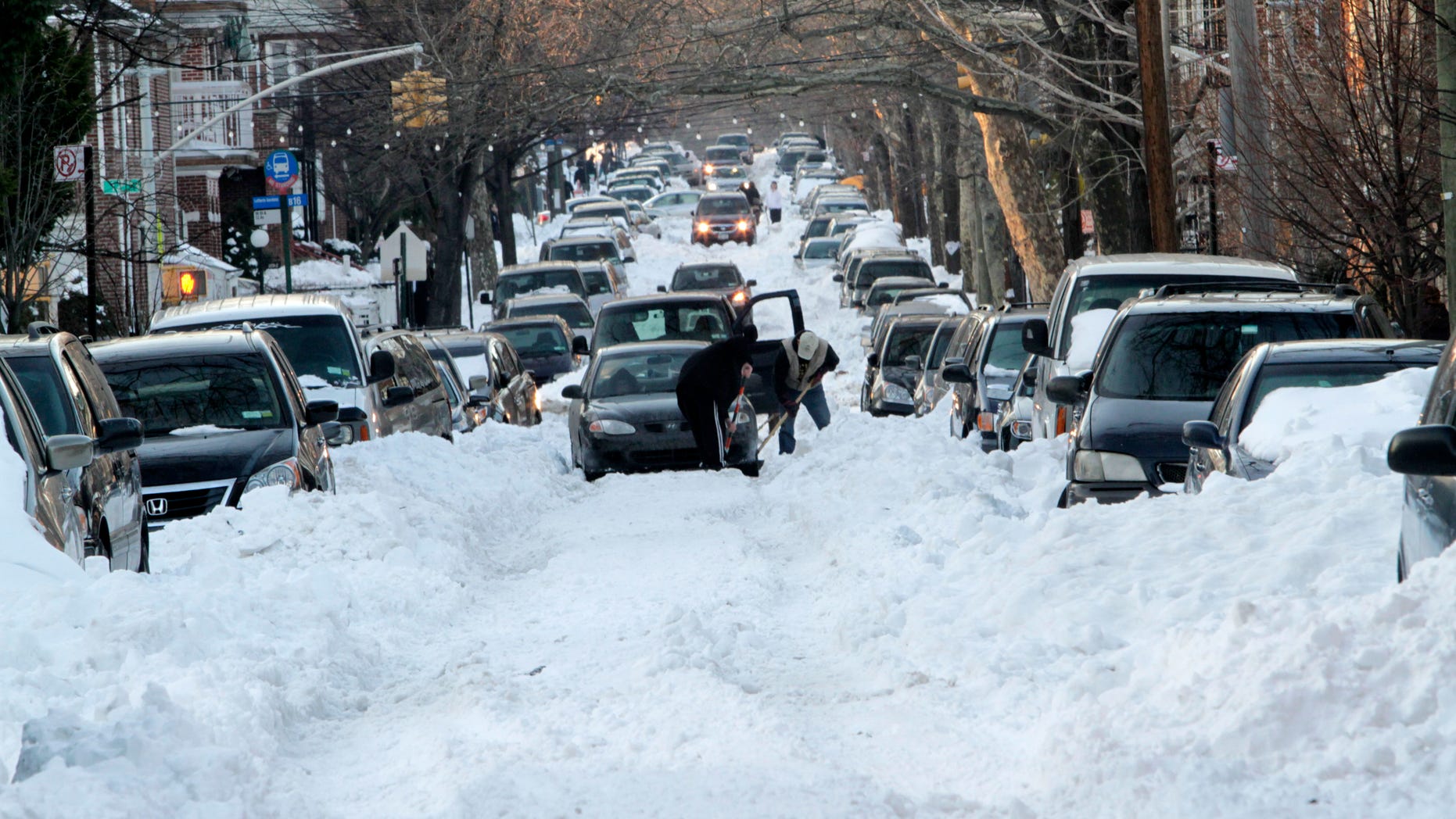 Dec. 29: People work to free a car stuck on the unplowed 56th street in the Boro Park neighborhood of the Brooklyn Borough of New York.