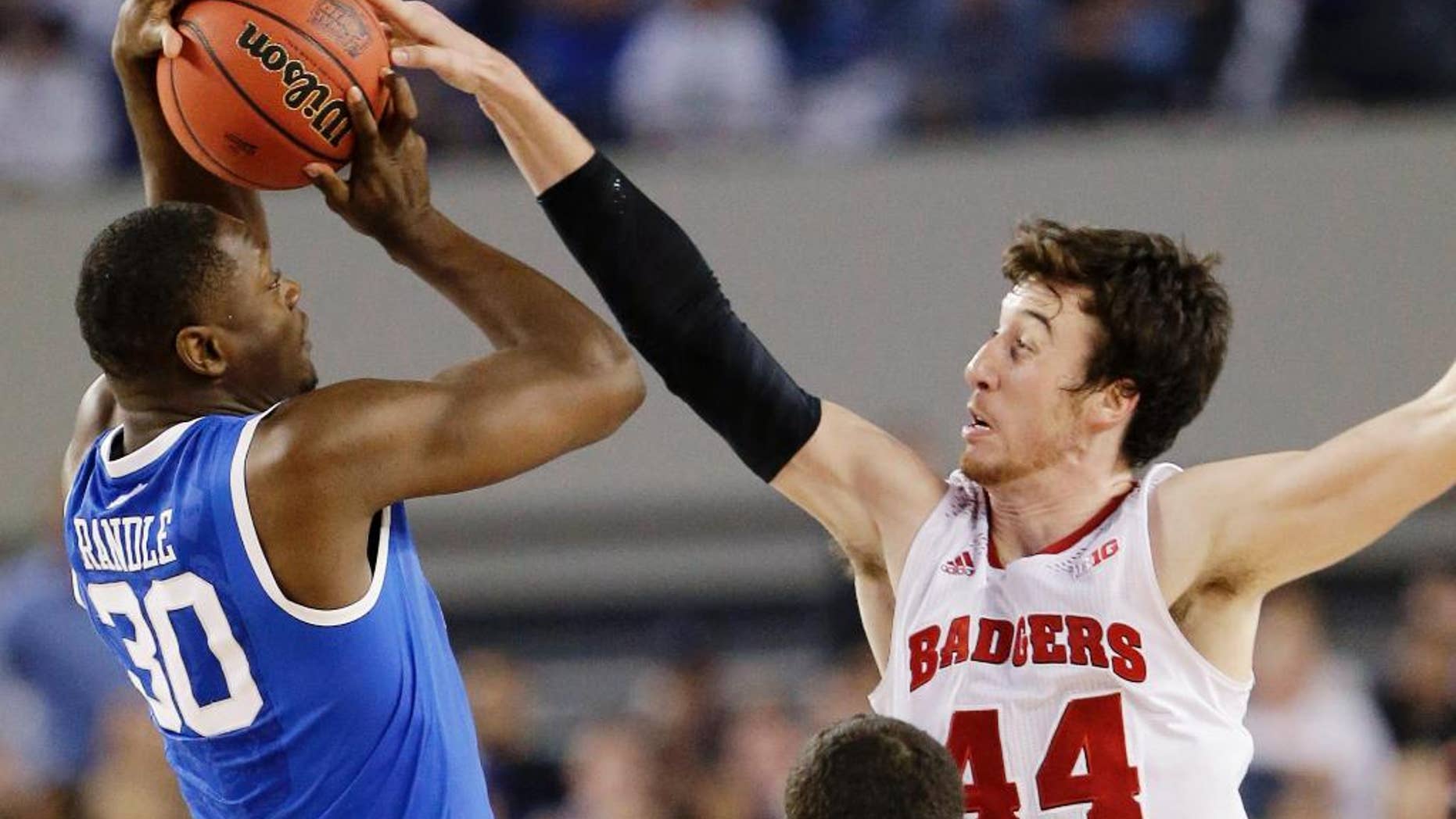 FILE - In this April 5, 2014, file photo, Wisconsin forward Frank Kaminsky (44) blocks a shot by Kentucky forward Julius Randle (30) during the second half of the NCAA Final Four tournament college basketball semifinal game in Arlington, Texas. The one-point loss to Kentucky in the Final Four still stings for Kaminsky. But instead of stewing all offseason about his team being one possession short of playing for a national title, Kaminsky says it's all about motivation. (AP Photo/Eric Gay, File)