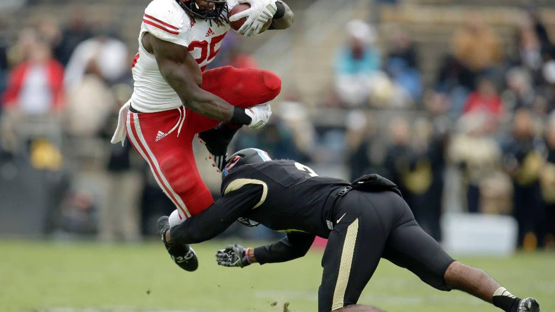 Wisconsin running back Melvin Gordon, left, leaps to avoid a tackle by Purdue defensive back Leroy Clark during the second half of an NCAA college football game in West Lafayette, Ind., Saturday, Nov. 8, 2014. Wisconsin won 34-16. (AP Photo/AJ Mast)