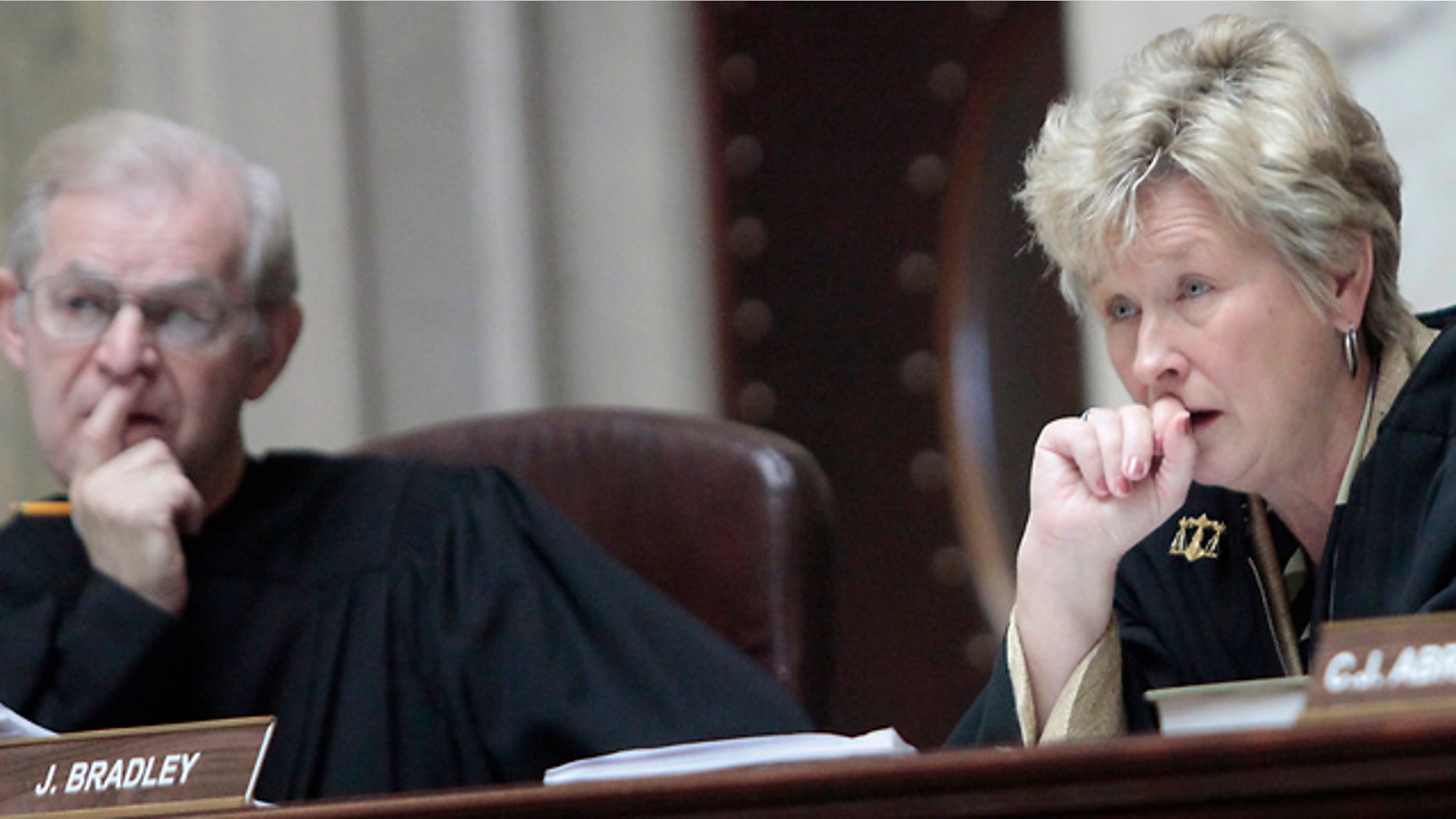 June 6: Wisconsin Supreme Court Justices David T. Prosser, Jr. and Ann Walsh Bradley consider oral arguments during a hearing regarding the state's budget bill at the Wisconsin State Capitol. According to a report by Wisconsin Public Radio and the Wisconsin Center for Investigative Journalism, Prosser allegedly grabbed Bradley by the neck with both hands during an argument in Walsh's chambers prior to the court's decision to uphold the bill.