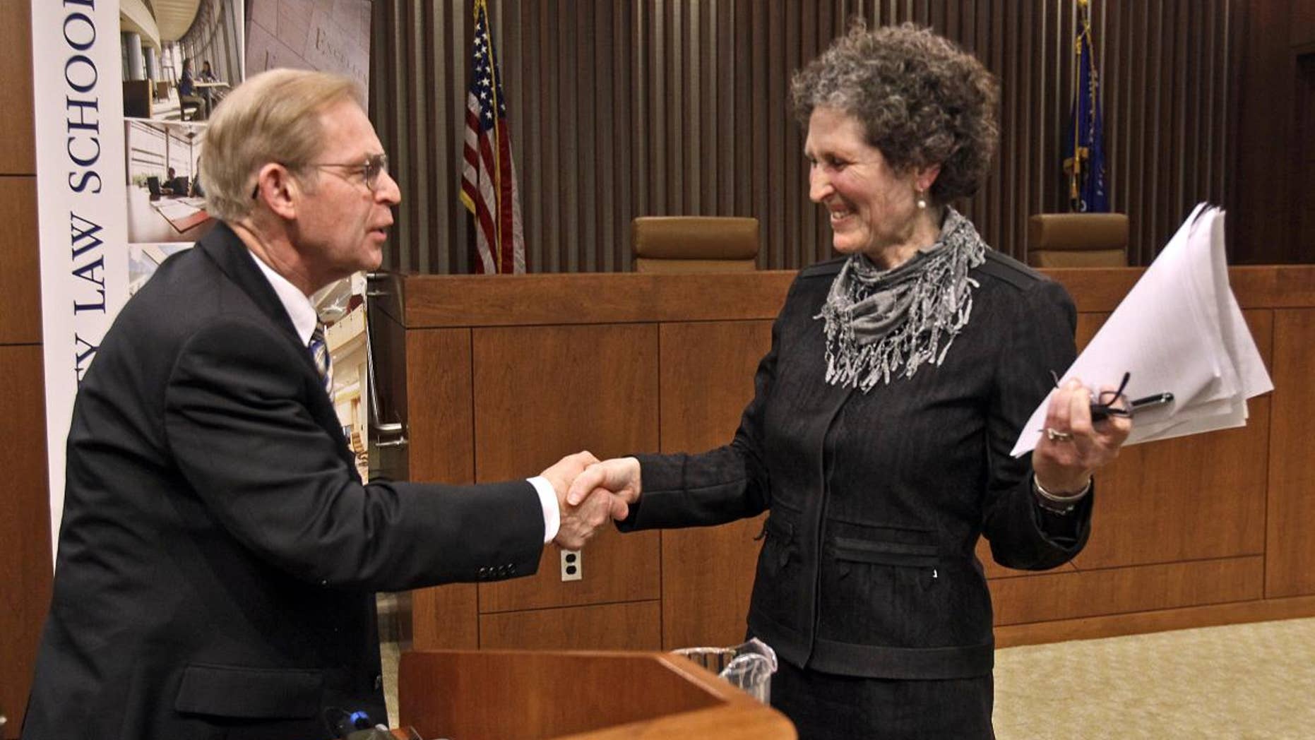 Justice David Prosser shakes hands with Assistant Attorney General JoAnne Kloppenburg after their debate for the Wisconsin Supreme Court at the Marquette University Law School in Milwaukee. (AP Photo/Milwaukee Journal-Sentinel, Benny Sieu)