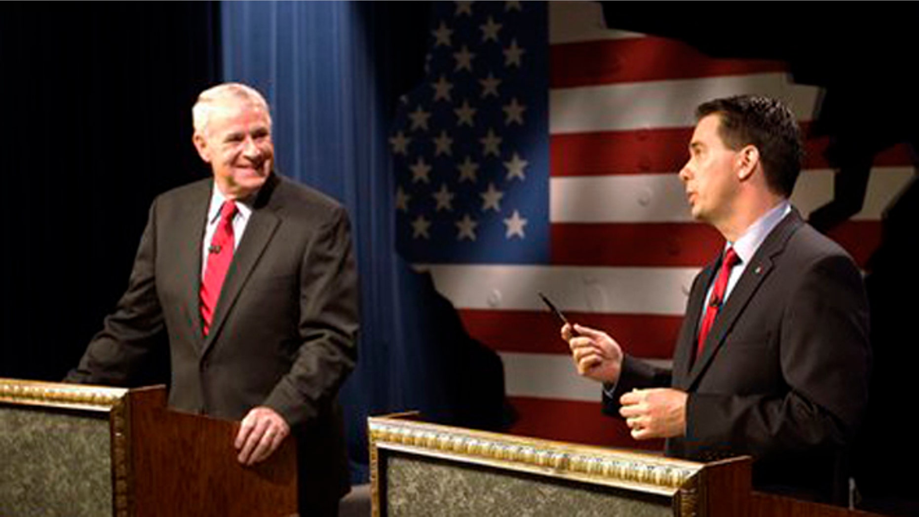 May 25, 2012: Wisconsin GOP Gov. Scott Walker, right, and Democratic challenger Tom Barrett get ready to participate in a televised debate.