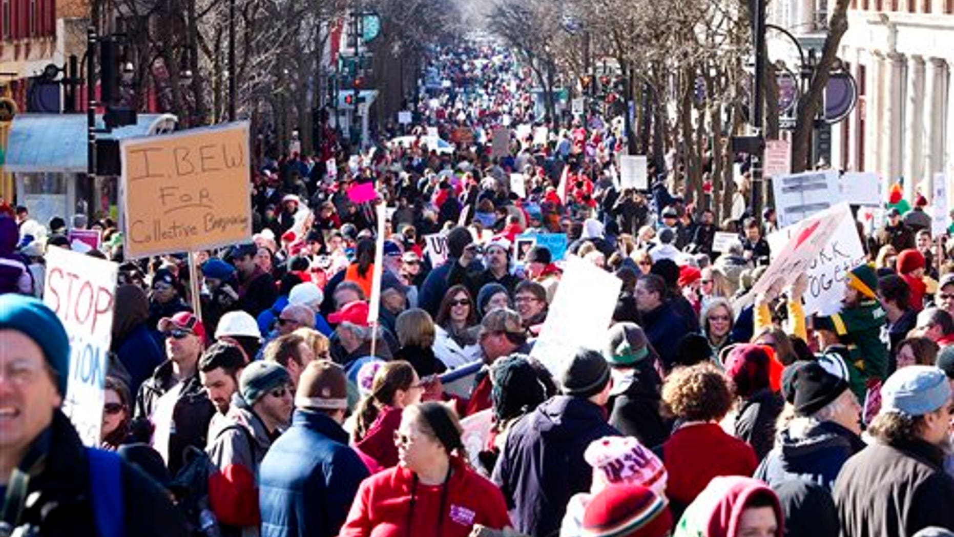 Saturday: Protesters gather down State Street in Madison, Wis., after a rally outside the Wisconsin State Capitol. A few dozen police officers stood between supporters of GOP Gov. Scott Walker on the muddy east lawn of the Capitol and the much larger group of pro-labor demonstrators who surrounded them.
