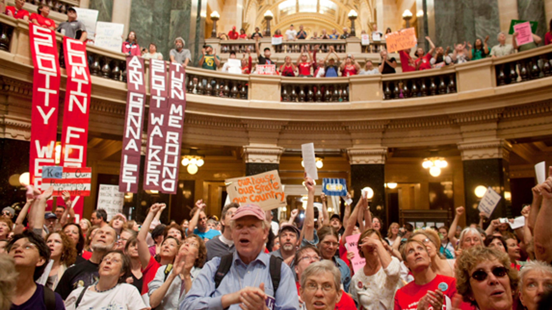 FILE: June 14, 2011: Protesters, including supporters of public employee unions, at the State Capitol Building, in Milwaukee, Wisc.