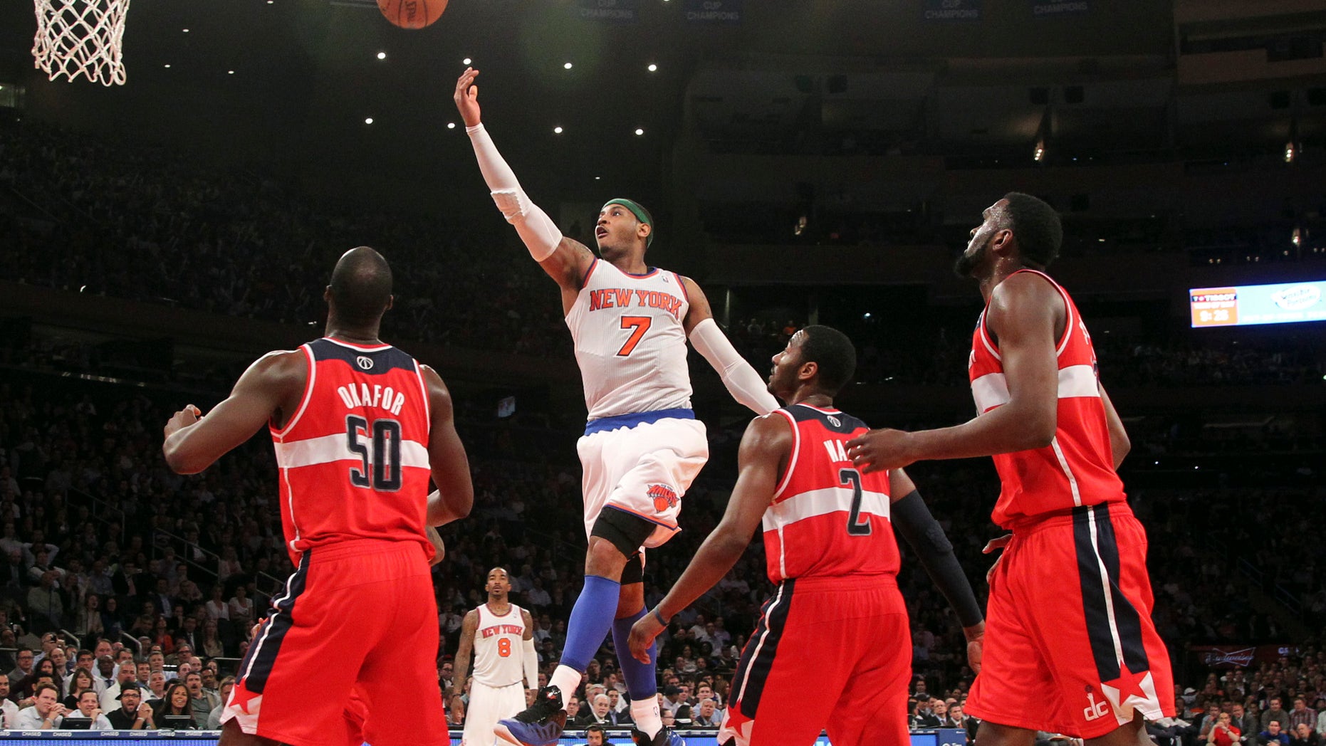New York Knicks' Carmelo Anthony (7) goes up past Washington Wizards' Emeka Okafor (50) John Wall and Chris Singleton during the second half of n NBA basketball game, Tuesday, April 9, 2013, at Madison Square Garden in New York. The Knicks won 120-99. (AP Photo/Mary Altaffer)