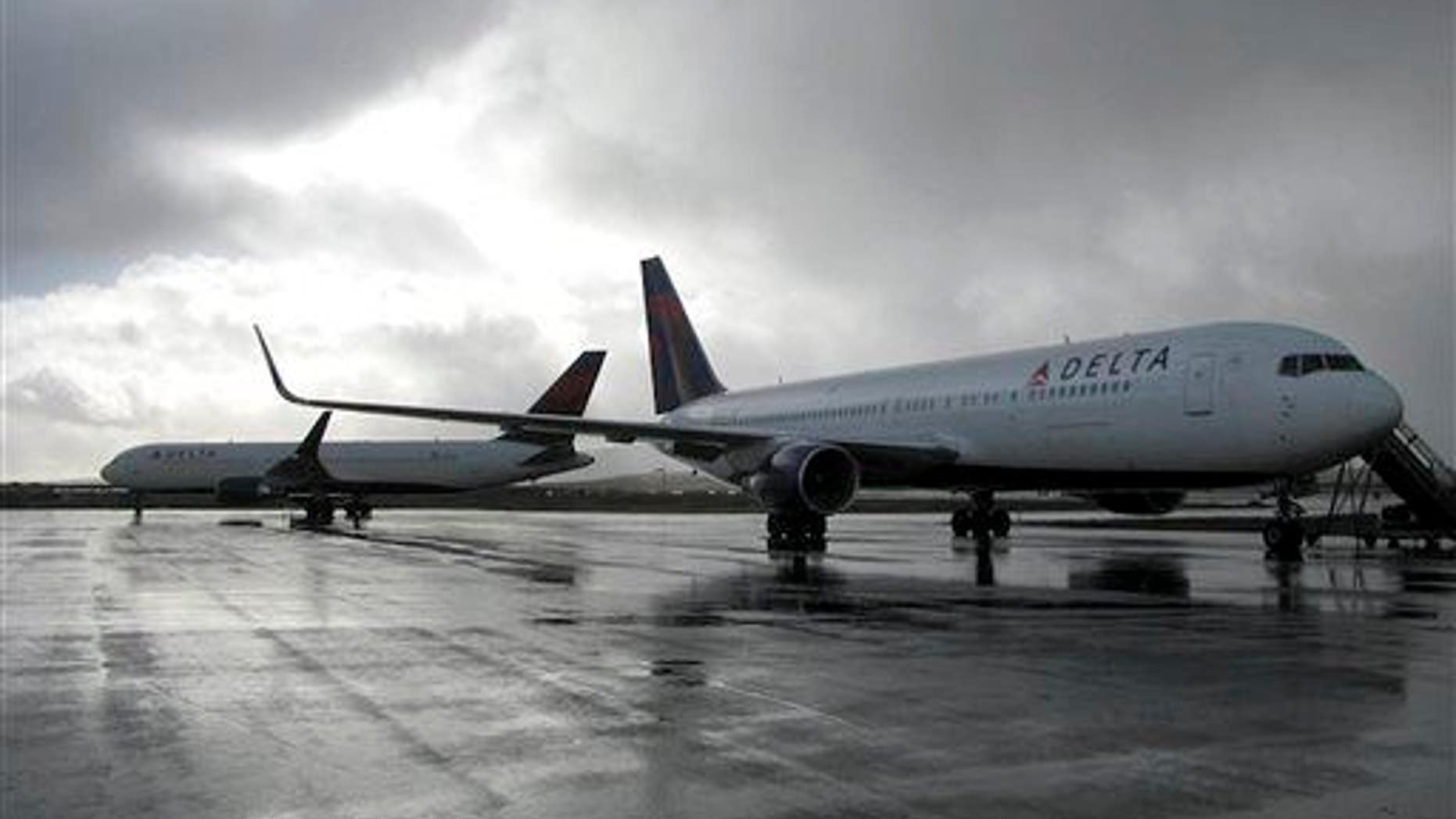 This Oct. 30, 2013 photo released by the State of Alaska Central Region Department of Transportation & Public Facilities shows a Delta Airlines plane on a runway, at right, in Cold Bay, Alaska.