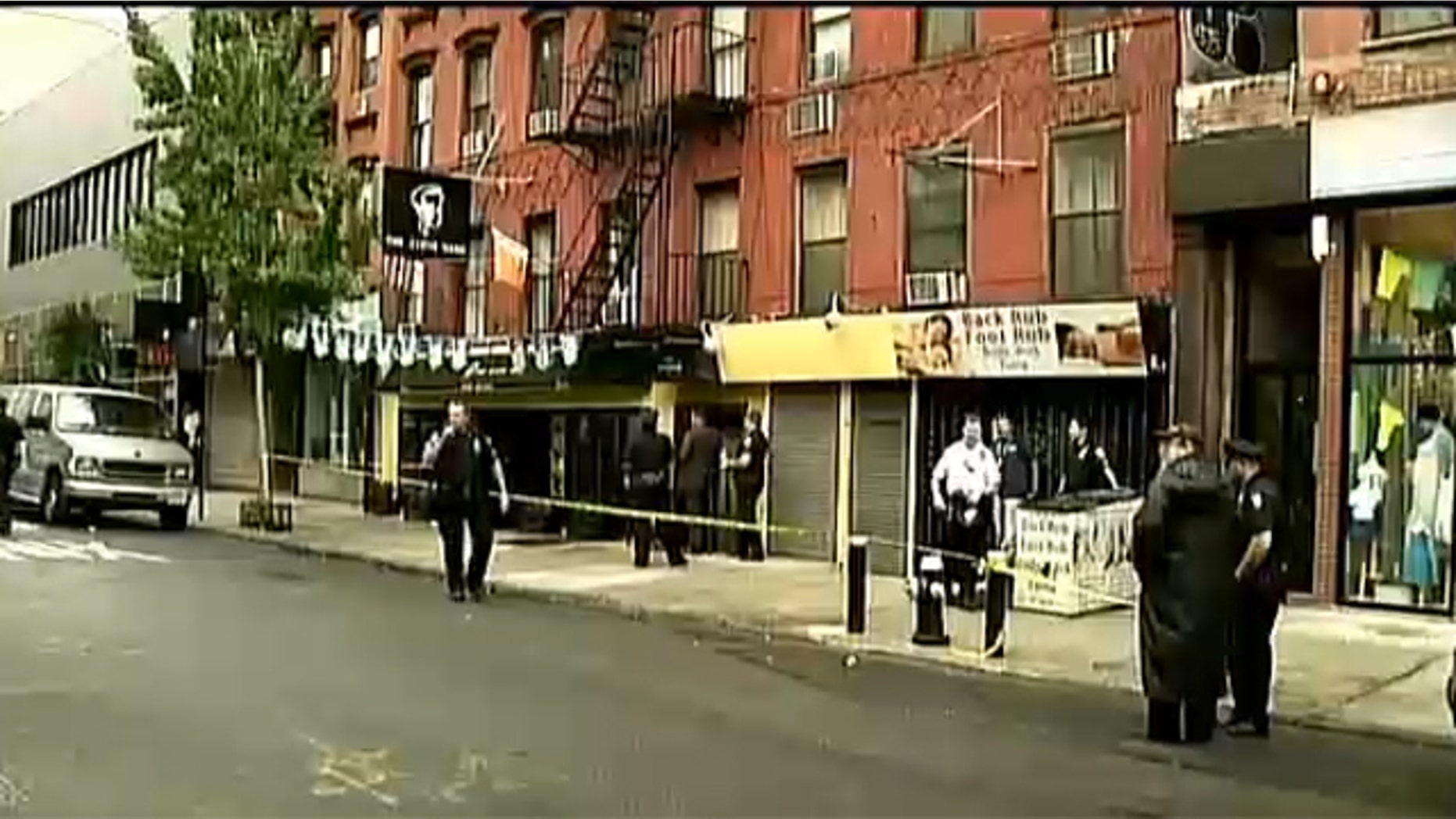 Aug. 27, 2012: Investigators work outside apartment building where woman found dead.