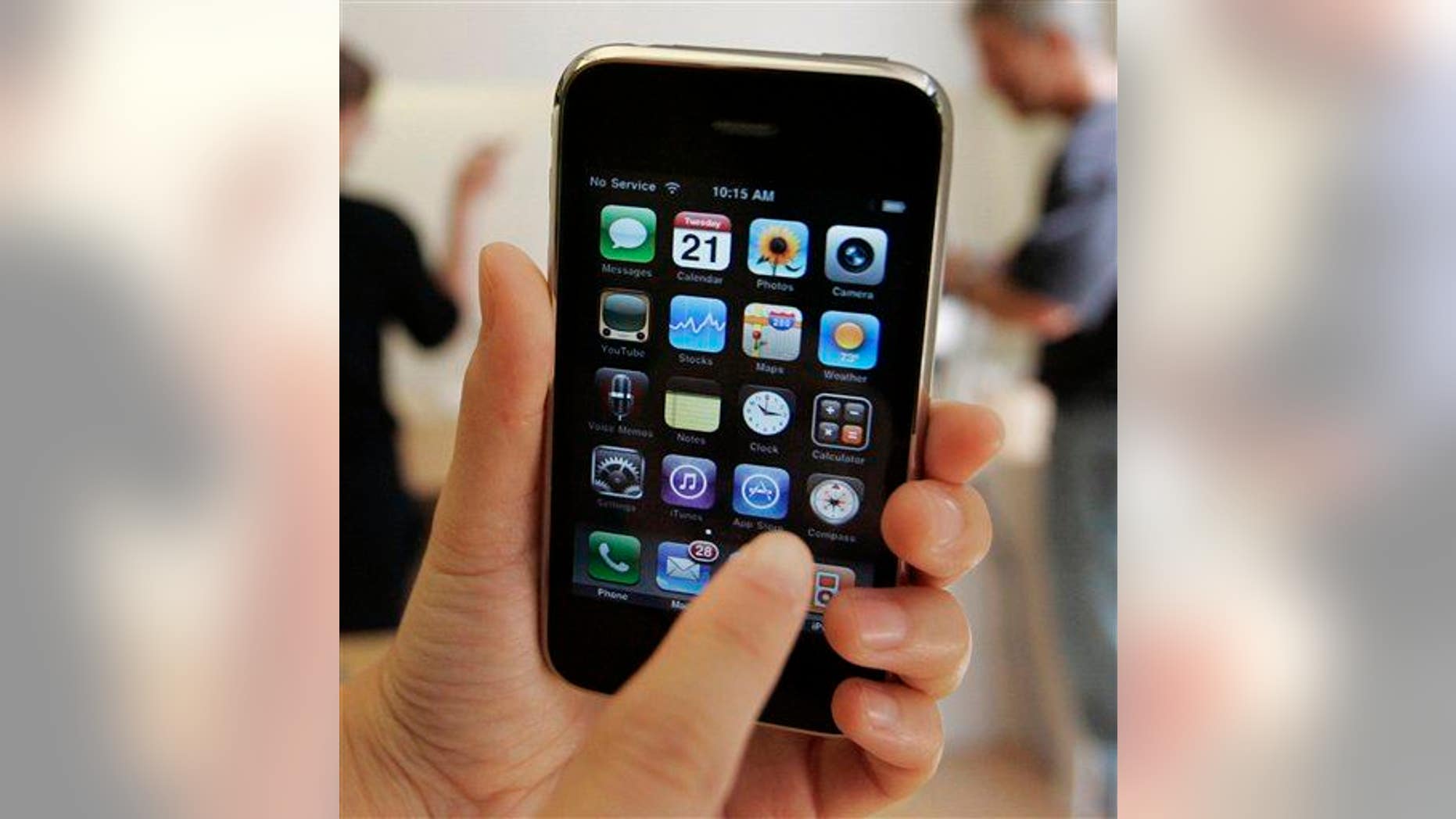 In this July 21, 2009, file photo, a customer displays an Apple iPhone 3GS at an Apple store in Palo Alto, Calif.