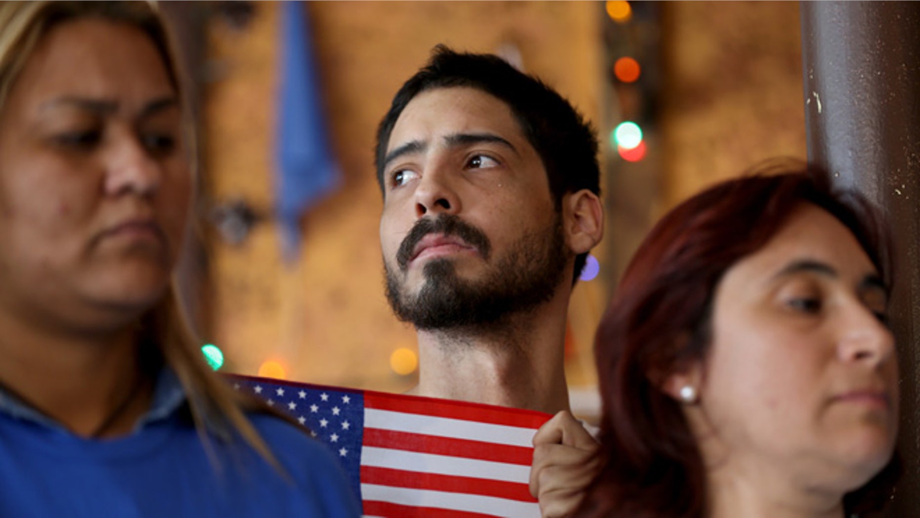 Dian Alarcon, originally from Colombia, stands with others during a press conference to protest the district court judge in Brownsville, Texas, who issued a preliminary injunction that temporarily blocks the implementation process of President Barack Obama's Executive Action on immigration on February 17, 2015 in Miami, Florida. (Photo by Joe Raedle/Getty Images)
