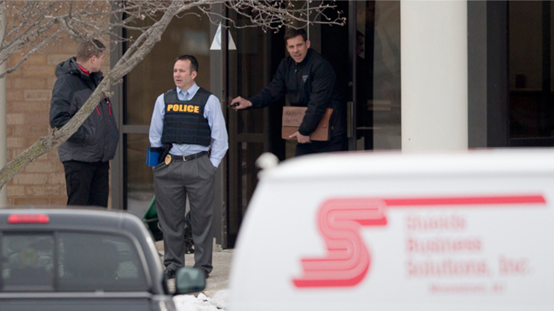 Feb. 23, 2015: Investigators stand at the scene of a shooting at a Shields Business Solutions office in Moorestown, N.J. (AP)