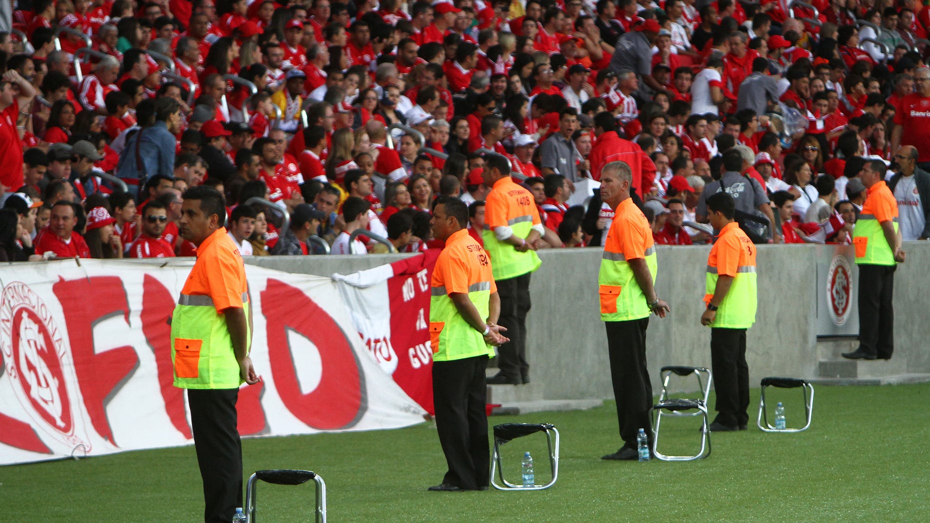 PORTO ALEGRE, BRAZIL - MAY 10: Stewards looks on Internacional fans before match between Internacional and Atletico-PR as part of Brasileirao Series A 2014 in Beira-Rio Stadium on May 10, 2014, in Porto Alegre, Brazil. This match is one of the test events for FIFA 2014 World Cup which Beira-Rio will host five games. (Photo by Lucas Uebel/Getty Images)