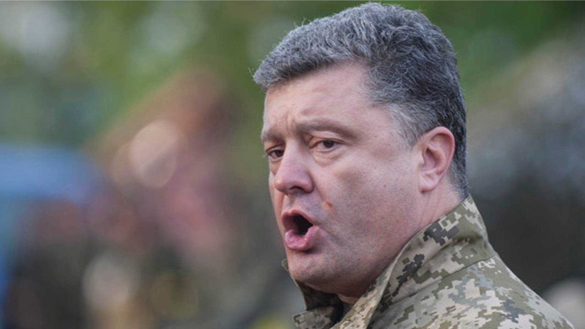 July 8, 2014: Ukrainian President Petro Poroshenko addresses troops as he visits their base in Devhenke, in the Kharkiv region of eastern Ukraine. (AP Photo/Evgeniy Maloletka)