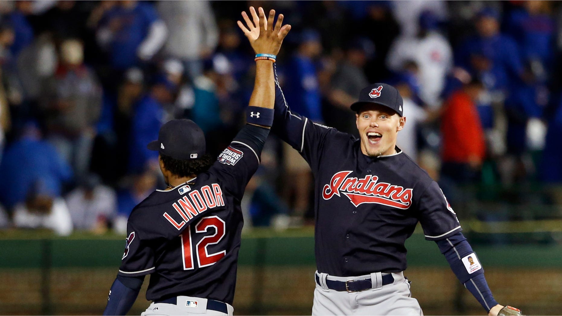 Cleveland Indians' Brandon Guyer, right, celebrates with Francisco Lindor (12) after Game 4 of the Major League Baseball World Series against the Chicago Cubs, Saturday, Oct. 29, 2016, in Chicago. The Indians won 7-2 to take a 3-1 lead in the series. (AP Photo/Nam Y. Huh)