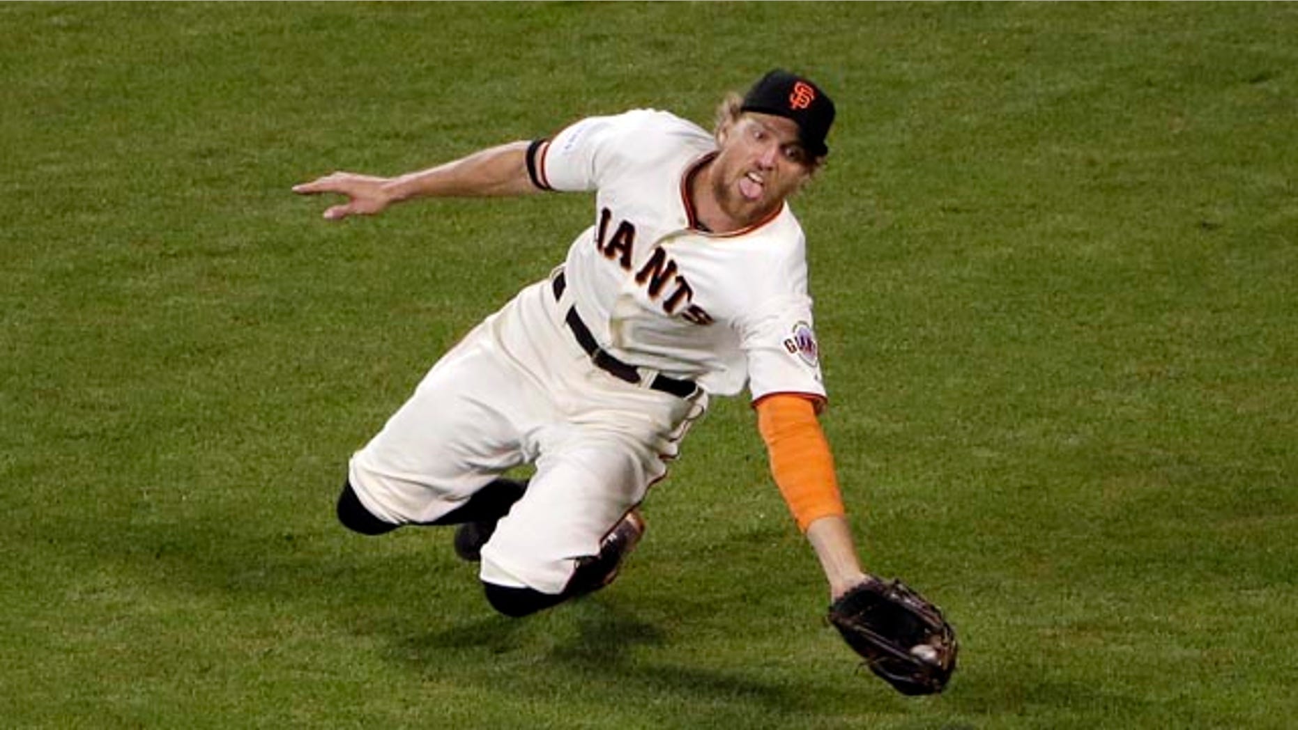 October 25, 2014: San Francisco Giants' Hunter Pence makes a diving catch for the out on a ball hit by Kansas City Royals' Lorenzo Cain during the ninth inning of Game 4 of baseball's World Series. (AP Photo/Marcio Jose Sanchez)