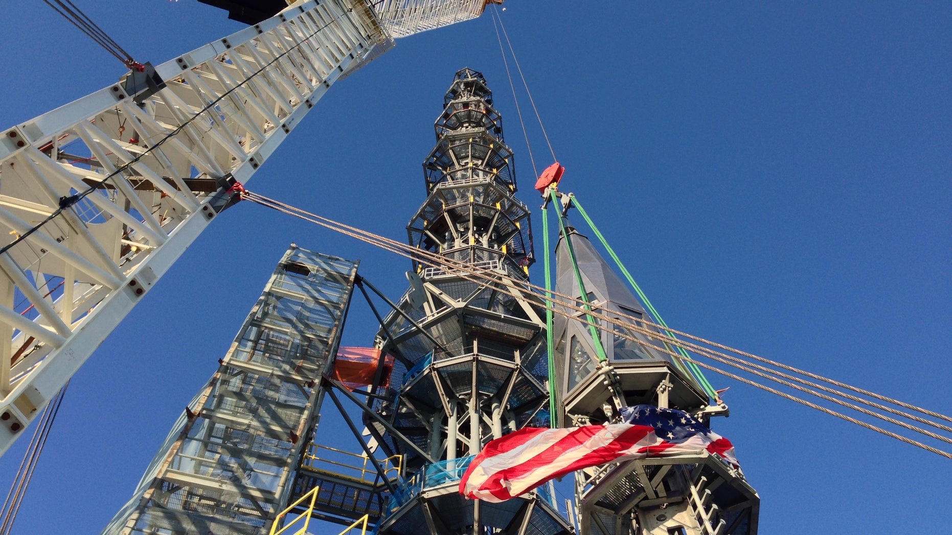 March 10, 2013: Workers prepare to raise the silver spire atop the 1 World Trade Center building in New York early.