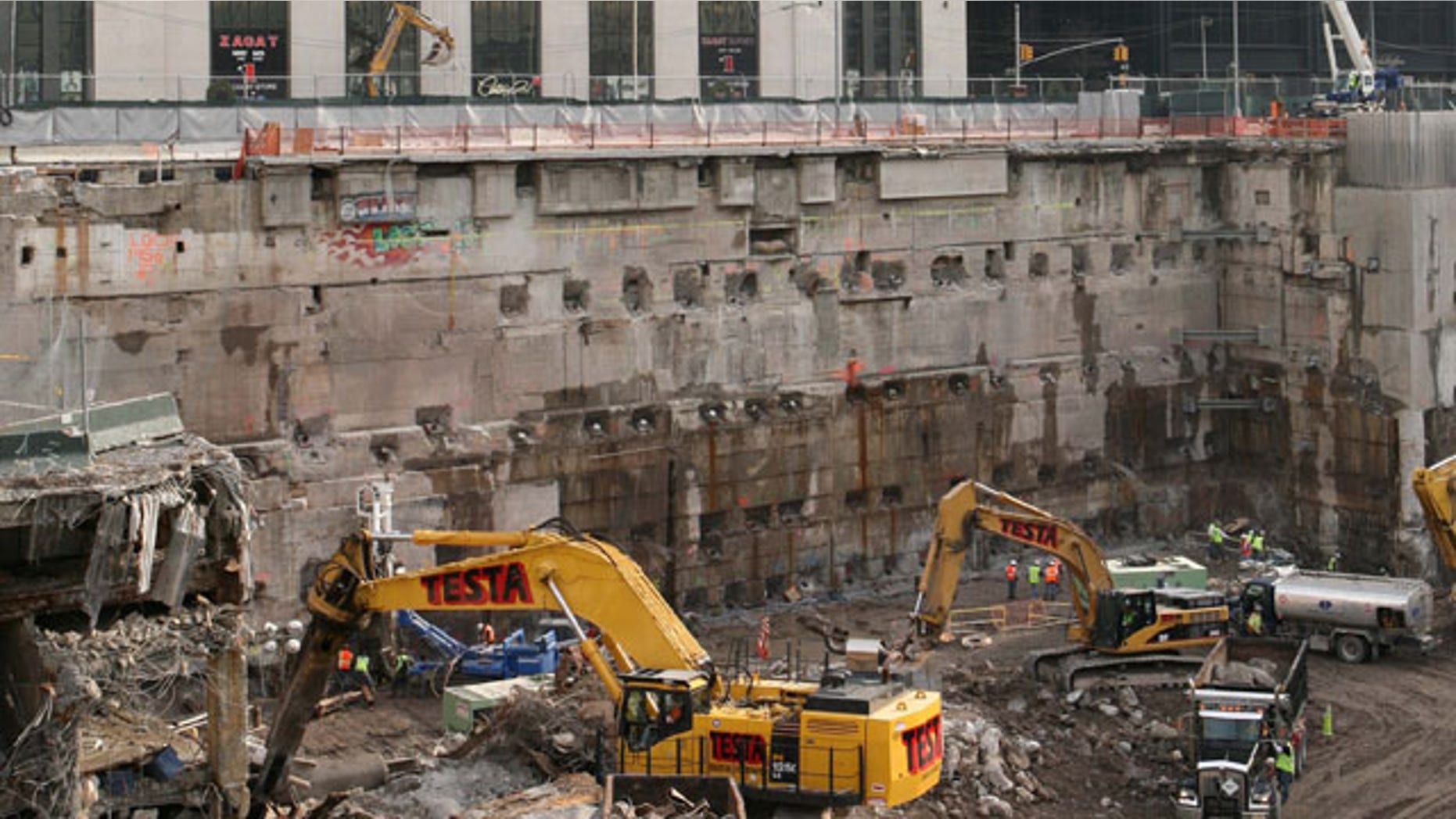 FILE: Construction workers and equipment excavate the southeastern corner of the World Trade Center site.