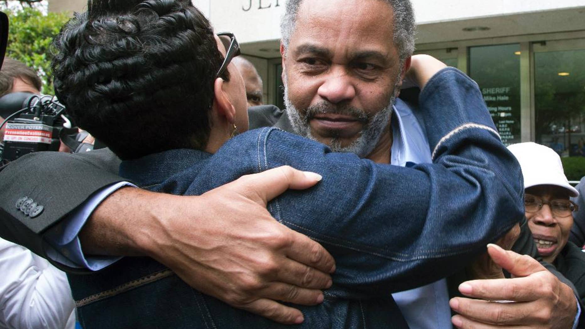 FILE - In this April 3, 2015 file photo, Pat Turner, left, hugs Anthony Ray Hinton as he leaves the Jefferson County jail in Birmingham, Ala. Hinton spent nearly 30 years on Alabama's death row, and was set free after prosecutors told a judge they won't re-try him for the 1985 slayings of two fast-food managers. Defense attorneys said the release of Hinton, after nearly 30 years on Alabama’s death row is an argument for the establishment of a conviction integrity unit to investigate claims of innocence. (AP Photo/Hal Yeager)