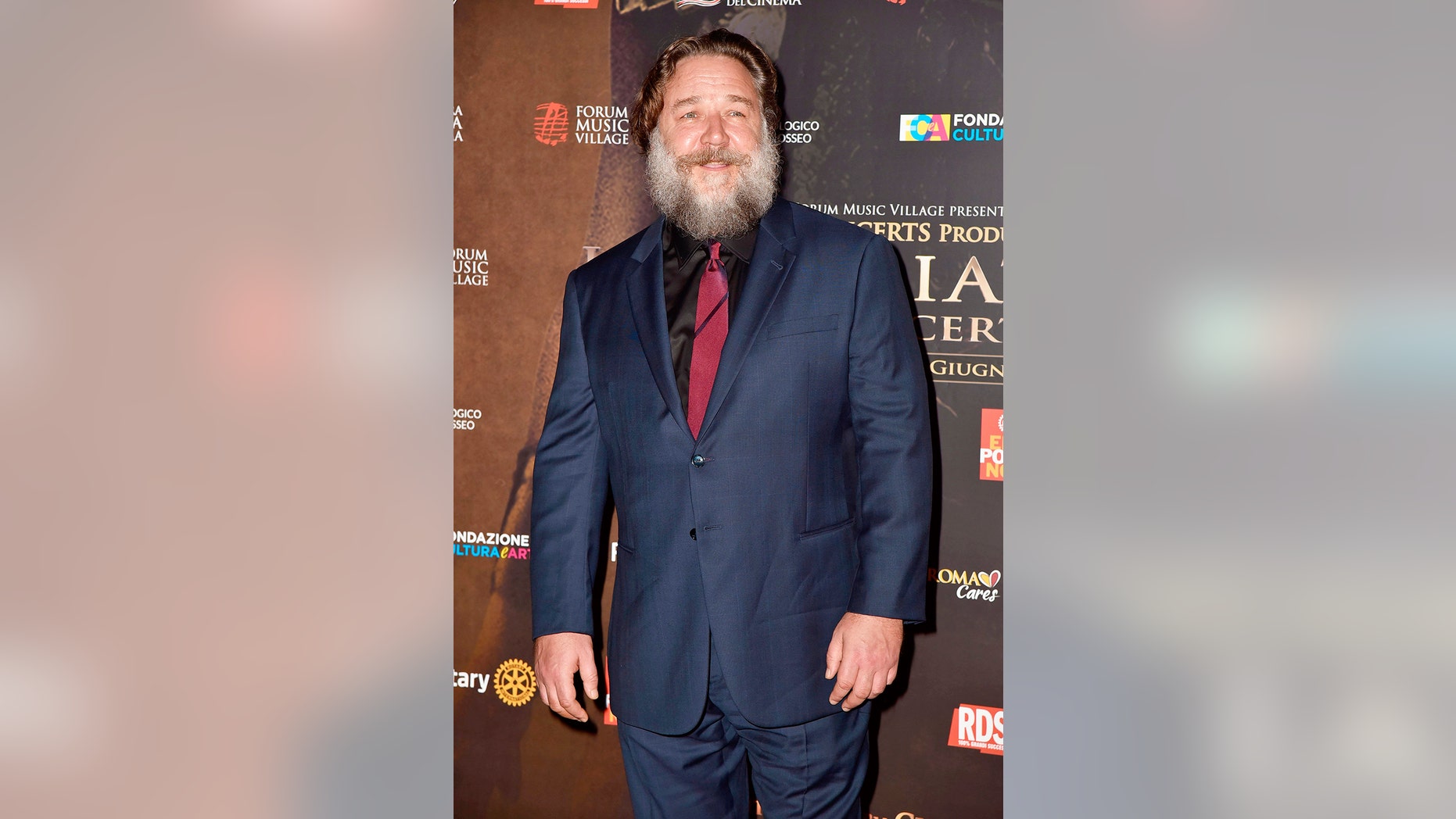 Russell Crowe displays his portly frame and bushy beard as he attends the "Gladiator in Concert" event with Connie Nielsen and Francesco Totti. June 6, 2018