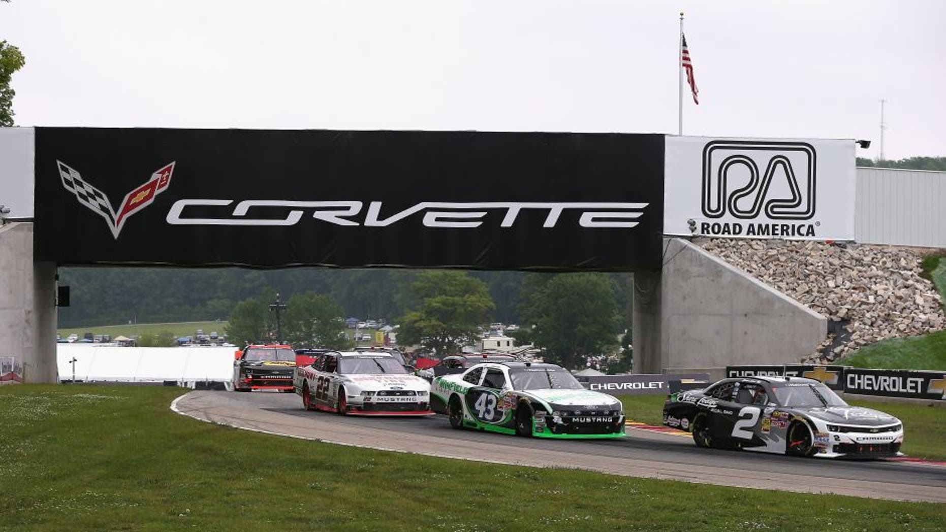 ELKHART LAKE, WI - JUNE 21: (L-R) Alex Tagliani, driver of the #22 Discount Tire Ford, Dakoda Armstrong, driver of the WinField Ford and Brian Scott, driver of the #2 Shore Lodge Chevrolet, move under a bridge during the Gardner Denver 200 Fired Up by Johnsonville race at Road America on June 21, 2014 in Elkhart Lake, Wisconsin. (Photo by Jonathan Daniel/Getty Images)