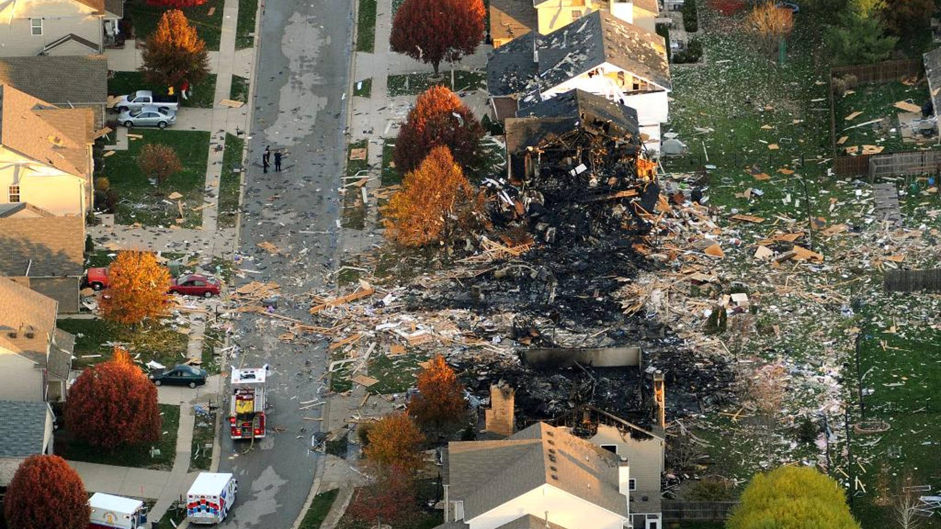 FILE - In this Nov. 11, 2012 file aerial photo are the two homes that were leveled and the neighboring homes that were damaged by a massive explosion that sparked a huge fire and killed two people in Indianapolis. Monserrate Shirley, the woman whose house exploded and one of three people charged in a deadly explosion, has reached a plea agreement, prosecutors said Friday, Jan. 16, 2015. Details were not immediately released. (AP Photo/The Indianapolis Star, Matt Kryger, File) NO SALES