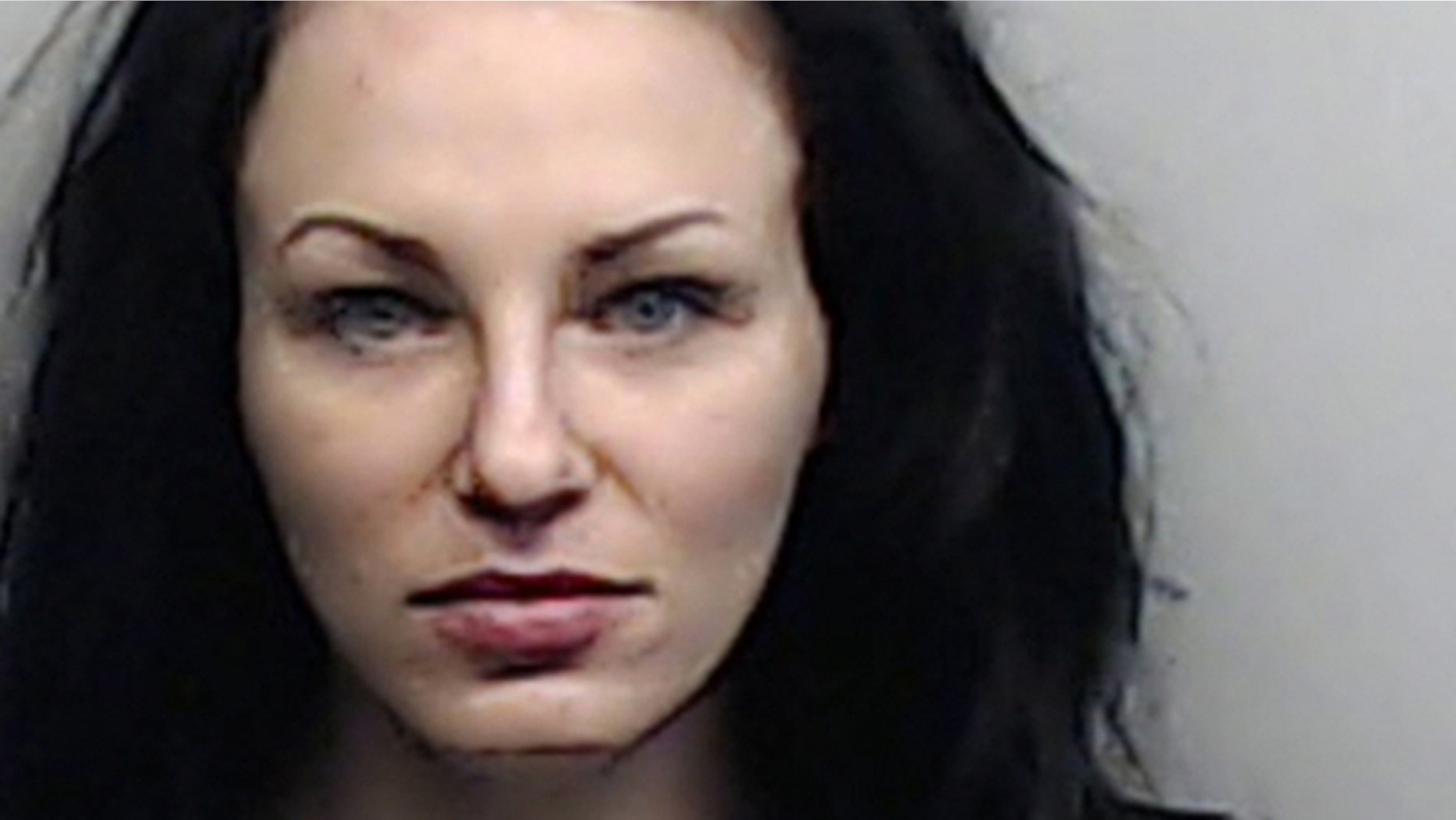 Fulton County Sheriff's Office, shows Alix Tichelman after her arrest on a battery charge, Sept. 6, 2013.