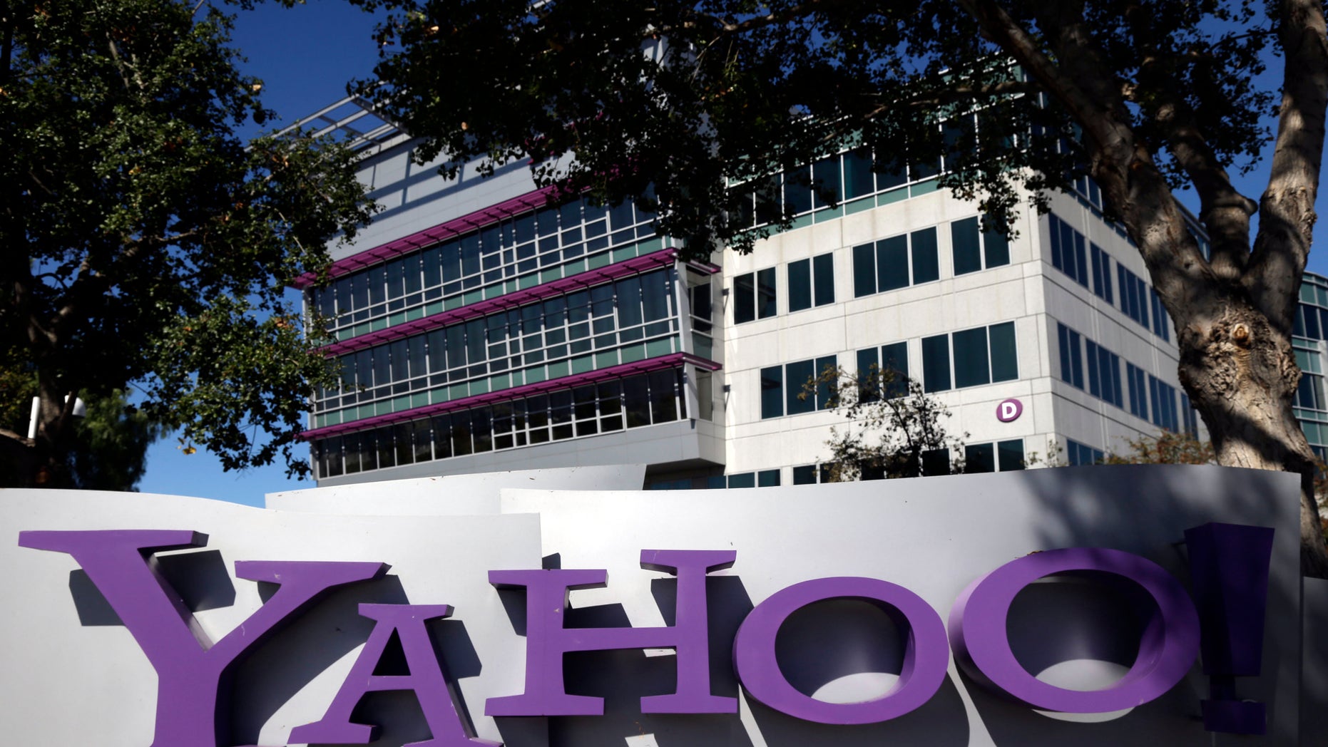 FILE - This Oct. 17, 2012, photo, shows a sign in front of Yahoo! headquarters in Sunnyvale, Calif. Yahoo says the government threatened to fine the company $250,000 a day if it did not comply with demands to go along with an expansion of U.S. surveillance laws by surrendering online information, a step the company regarded as unconstitutional. (AP Photo/Marcio Jose Sanchez, File)