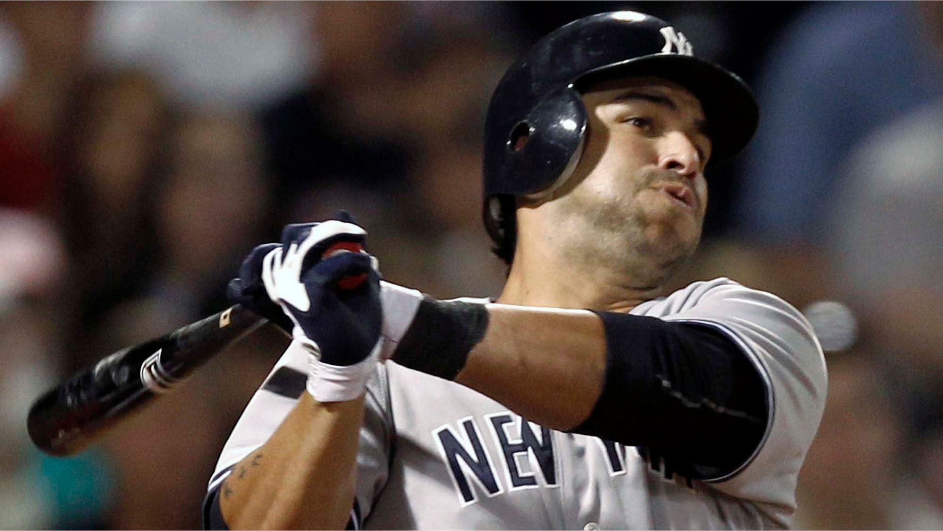 In this Aug. 31, 2011, file photo, New York Yankees' Eric Chavez follows through on a two-run double against the Boston Red Sox during the sixth inning of a baseball game in Boston. Chavez agreed to a $900,000, one-year deal with the Yankees on Thursday, Feb. 23, 2012.