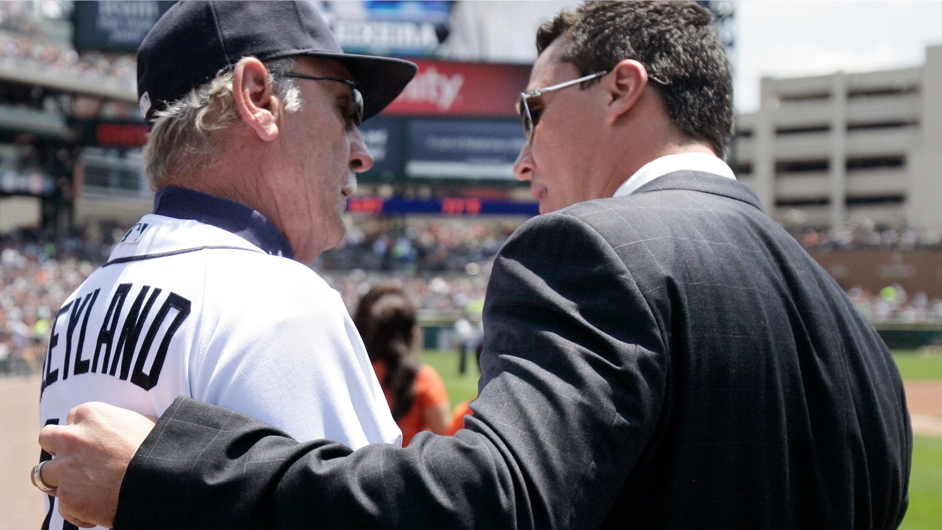 Former Detroit Tiger Magglio Ordonez, right, talks with Tigers manager Jim Leyland, left, following his retirement ceremony before a baseball game against the New York Yankees, Sunday, June 3, 2012, in Detroit. Ordonez has made his retirement official, ending a stellar career in which the outfielder hit .309 in 15 seasons with the Detroit Tigers and Chicago White Sox. (AP Photo/Duane Burleson)