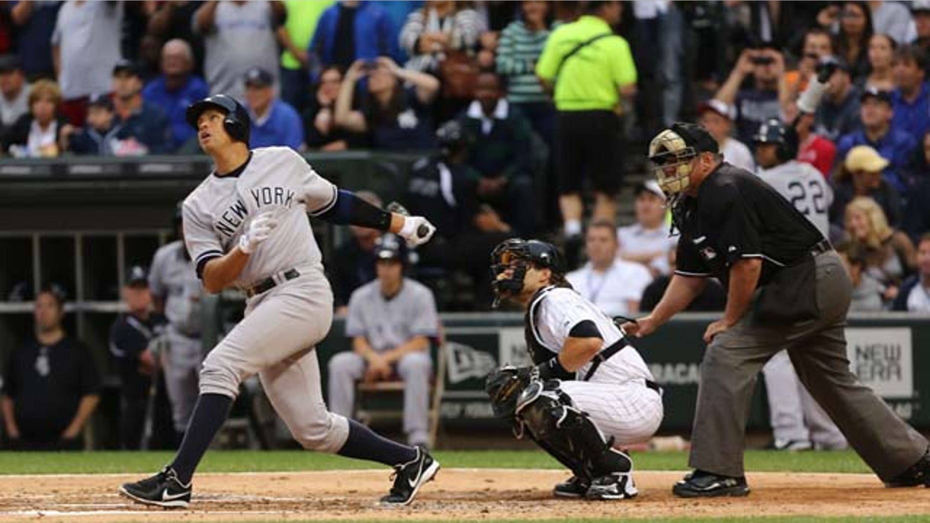 August 5, 2013: New York Yankees' Alex Rodriguez, left, gets a hit in his first at bat against the Chicago White Sox in the first inning in a baseball game at US Cellular Field in Chicago.