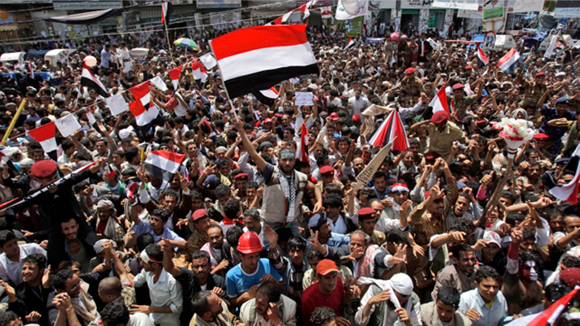 June 5: An anti-government protestor, center, waves his national flag while celebrating with others President Ali Abdullah Saleh's departure to Saudi Arabia, in Sanaa, Yemen.