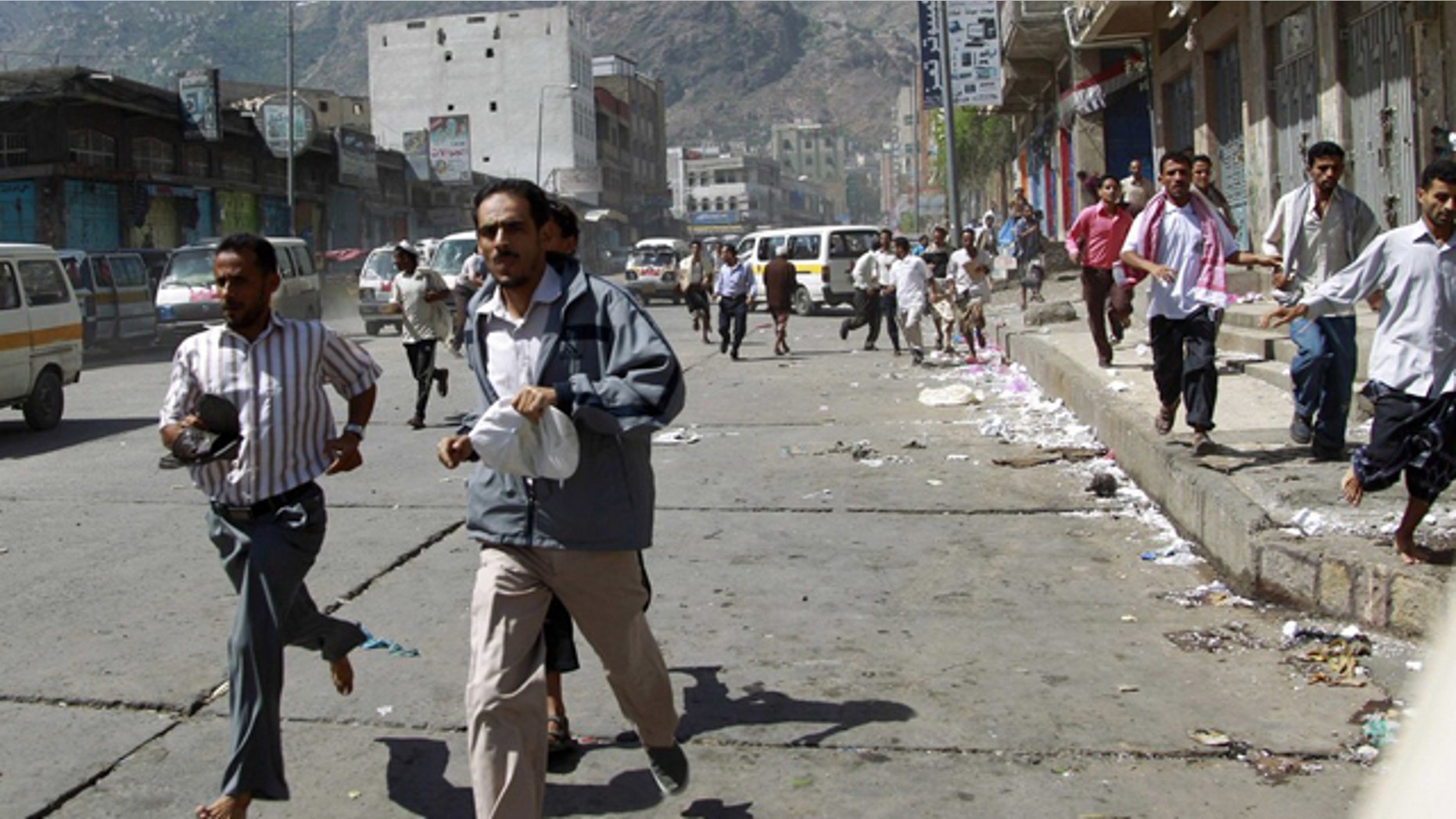 May 31: Government protesters run after soldiers opened fire to disperse them as they began gathering for a demonstration to demand the ouster of Yemen's President Ali Abdullah Saleh in the southern city of Taiz.