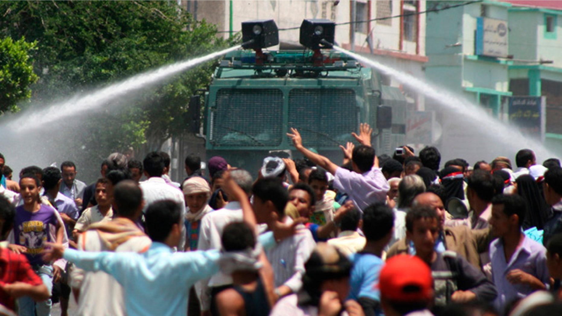 Sept. 20: Yemeni riot police use water cannons to disperse anti-government protestors during clashes, in Taiz, Yemen.