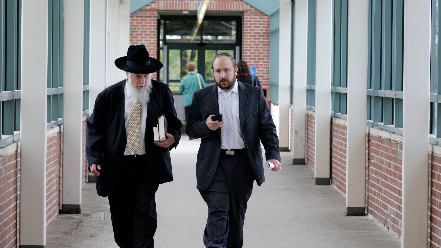May 9, 2013: Yosef Kolko, 39, right, walks with an unidentified man, near the Ocean County Courthouse in Toms River, N.J., during a break in his trial on sexual assault charges.