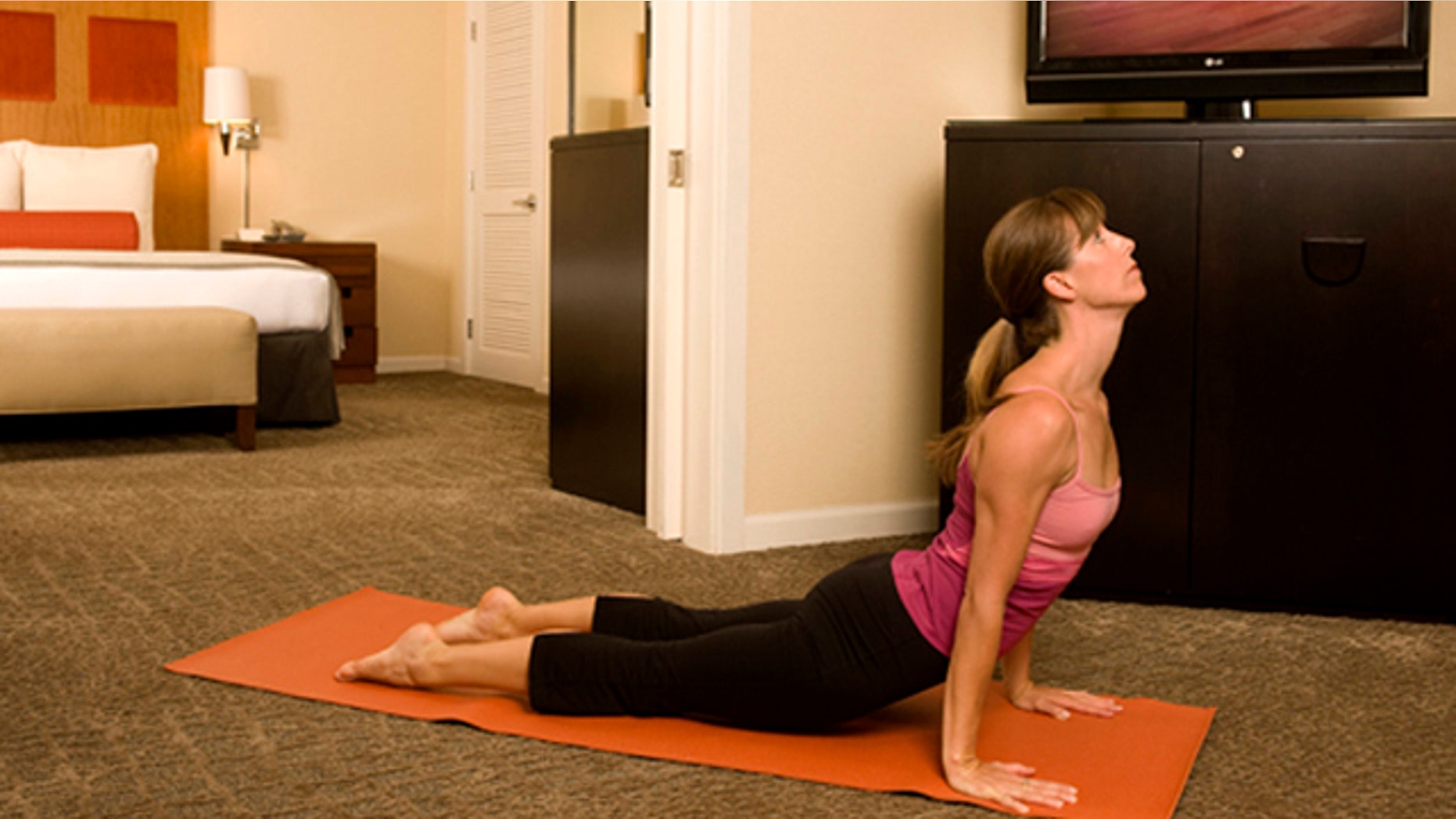 A woman practices yoga in Kimpton's Hotel Palomar in San Francisco, California.