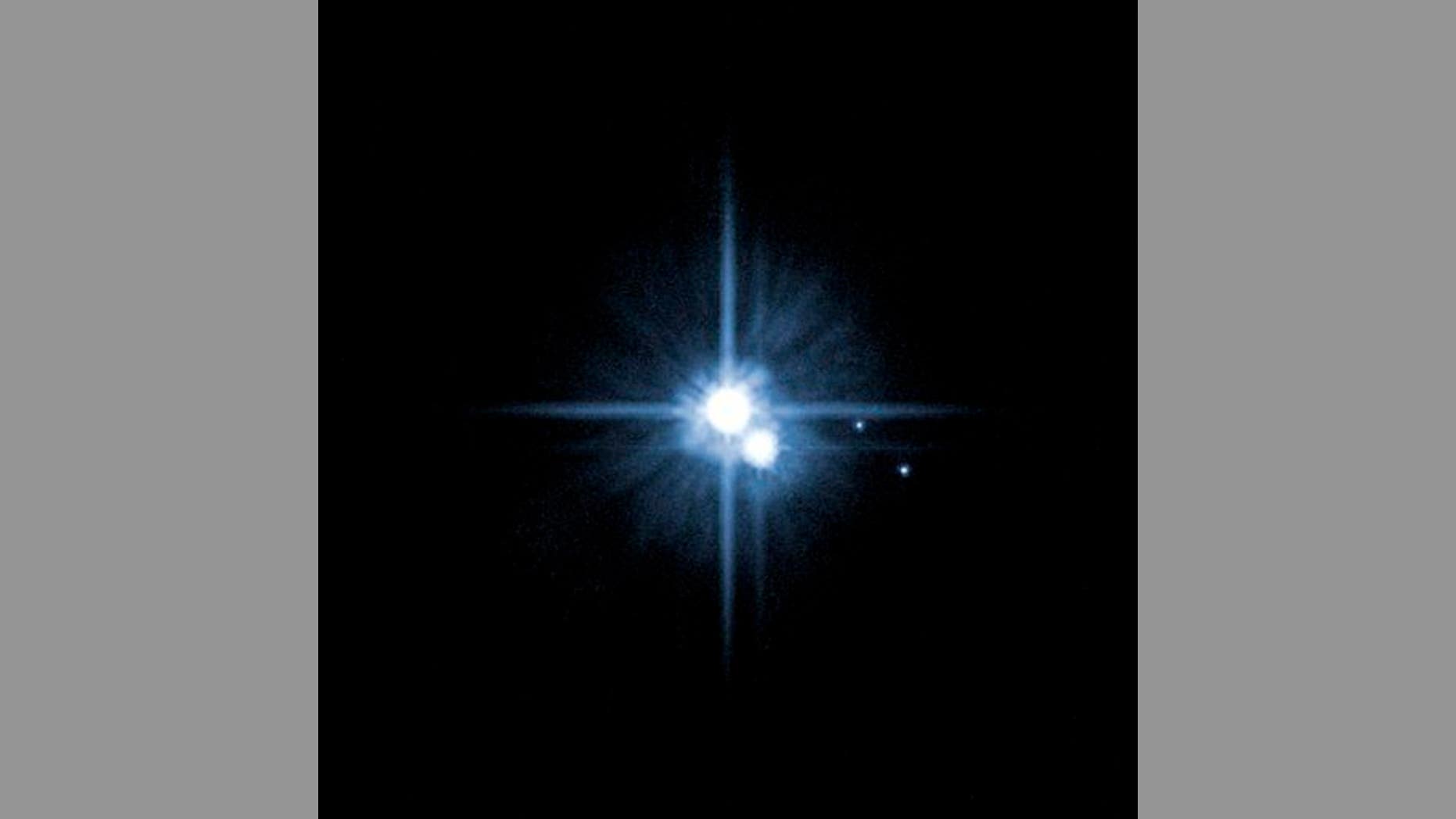 This file image provided by NASA on Feb. 22, 2006, from its Hubble Space Telescope shows Pluto and three of its five moons.