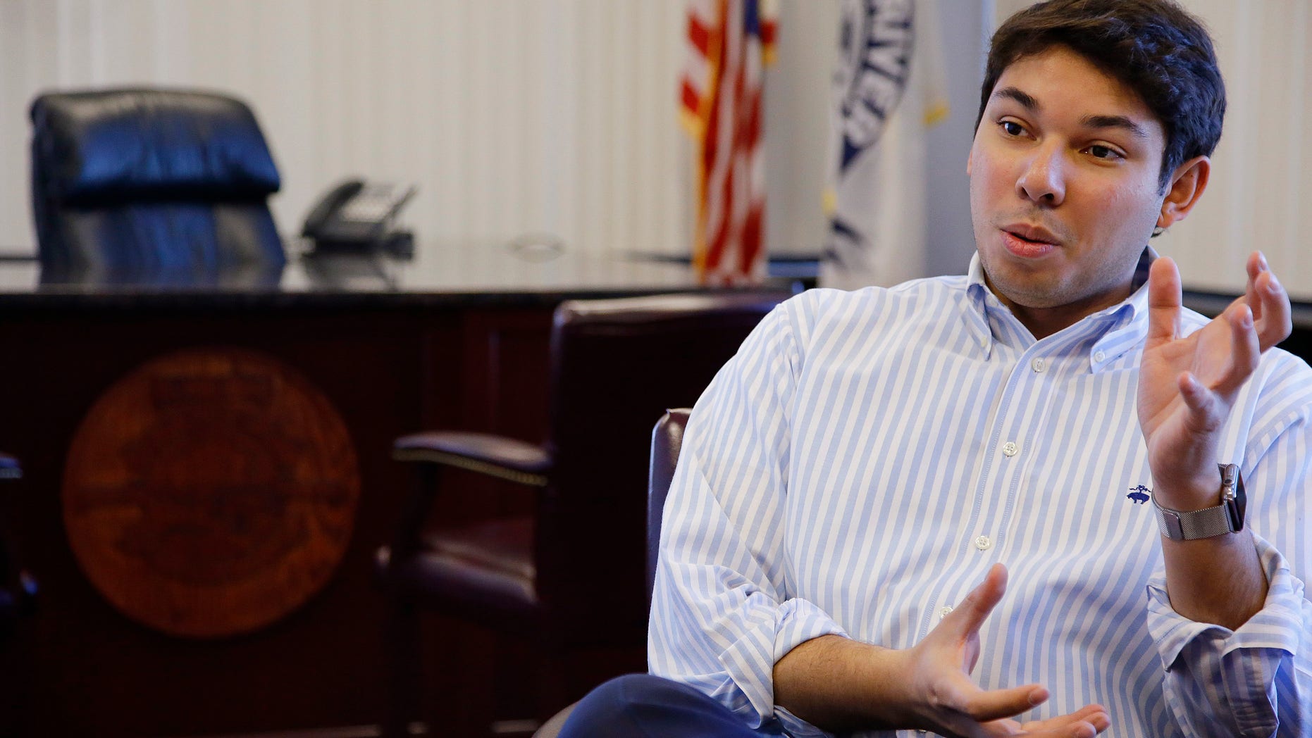 In this Wednesday, Jan. 6, 2016 photo newly elected Fall River Mayor Jasiel Correia has a conversation in his city hall office in Fall River, Mass. Correia, 24, is the youngest Fall River mayor to ever serve. (AP Photo/Stephan Savoia)