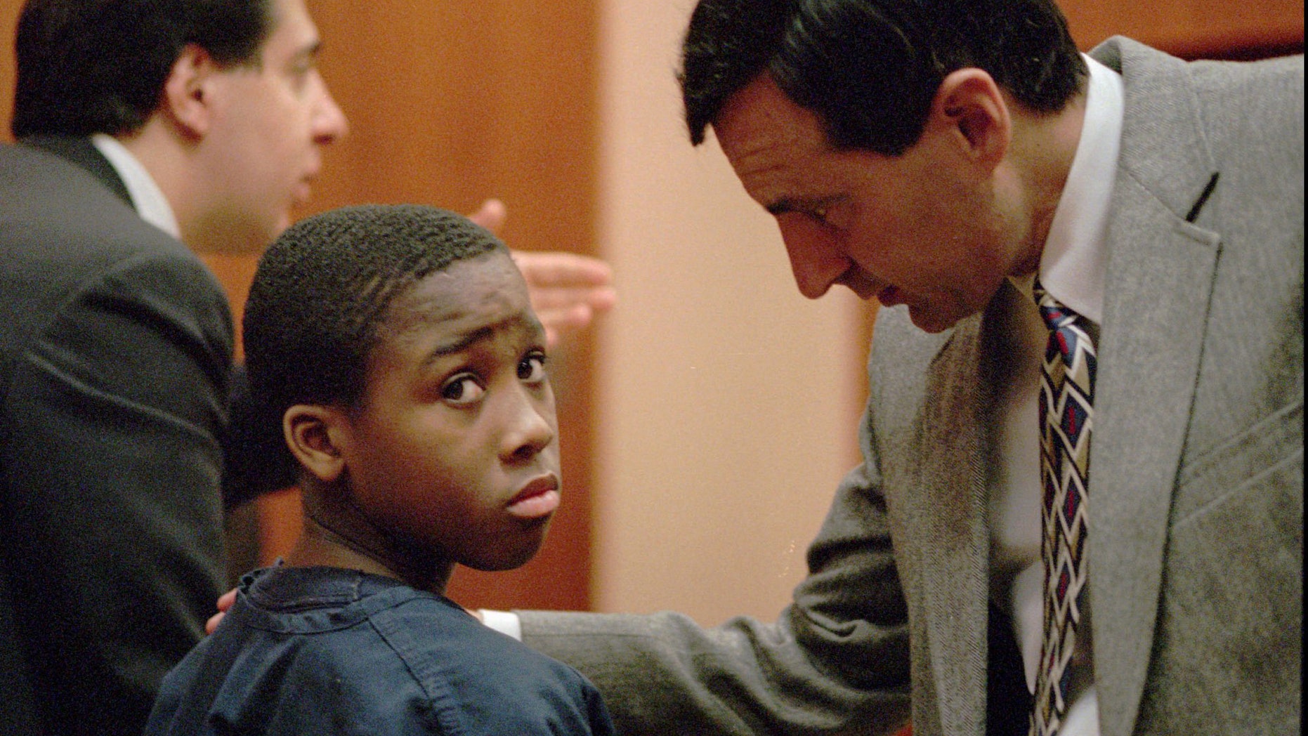 Feb. 11, 1998: Nathaniel Jamal Abraham, 12, of Pontiac, Mich., listens to his attorney in Juvenile court. Abraham, who committed murder at age 11, has been sentenced to five years of probation in a prison guard assault case.