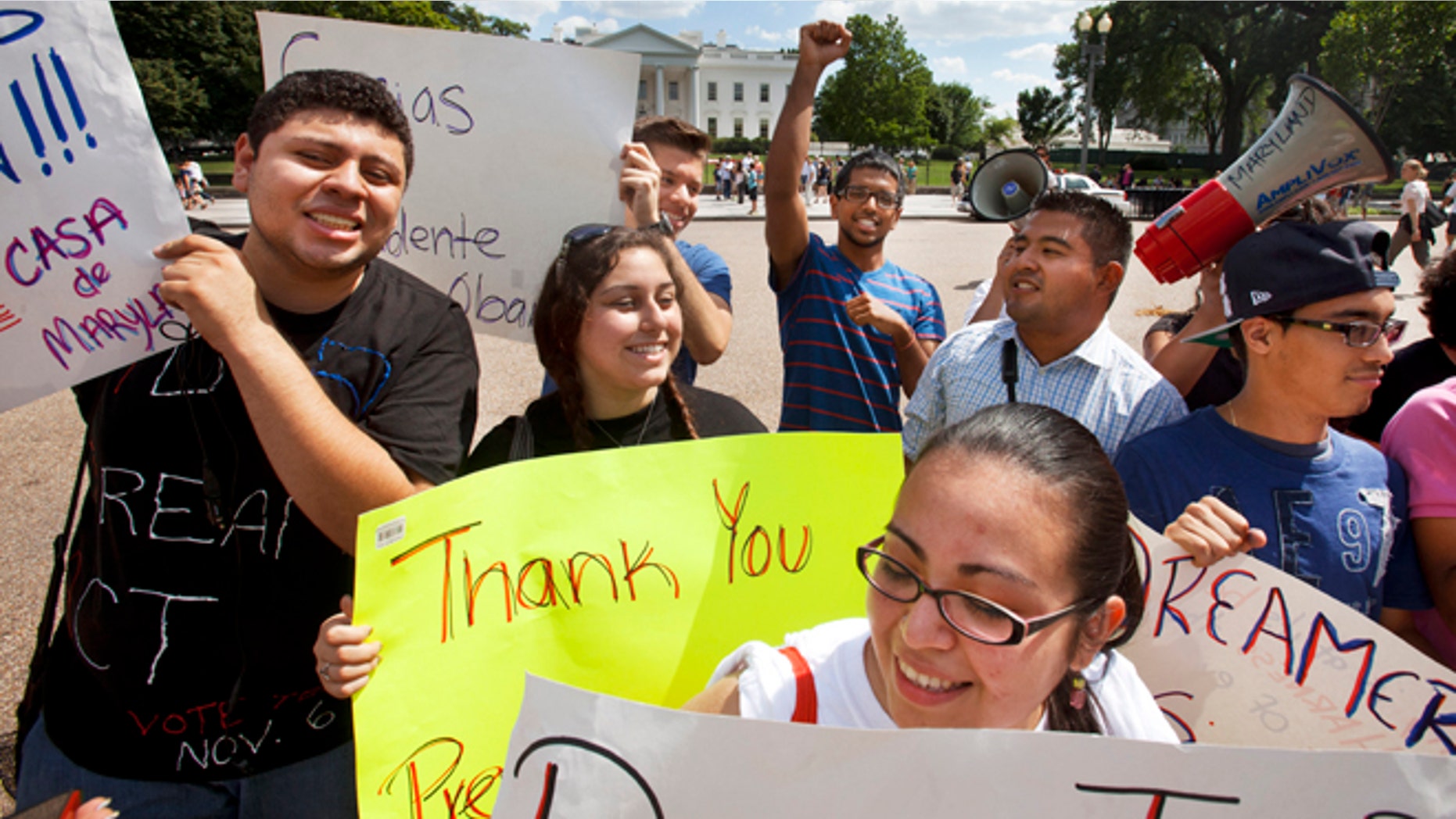 FILE - In this June 15, 2012 file photo, young demonstrators participate in a rally in support of President Barack Obama after the president announced that the U.S. government will stop deporting and begin granting work permits to younger illegal immigrants who came to the U.S. as children and have since led law-abiding lives. Young Hispanic and Asian-Americans who are immigrants themselves or have a parent who is are more likely to be liberal in their views on politics and immigration than those with families who have been in United States longer, a new GenForward poll shows. (AP Photo/Jacquelyn Martin, File)