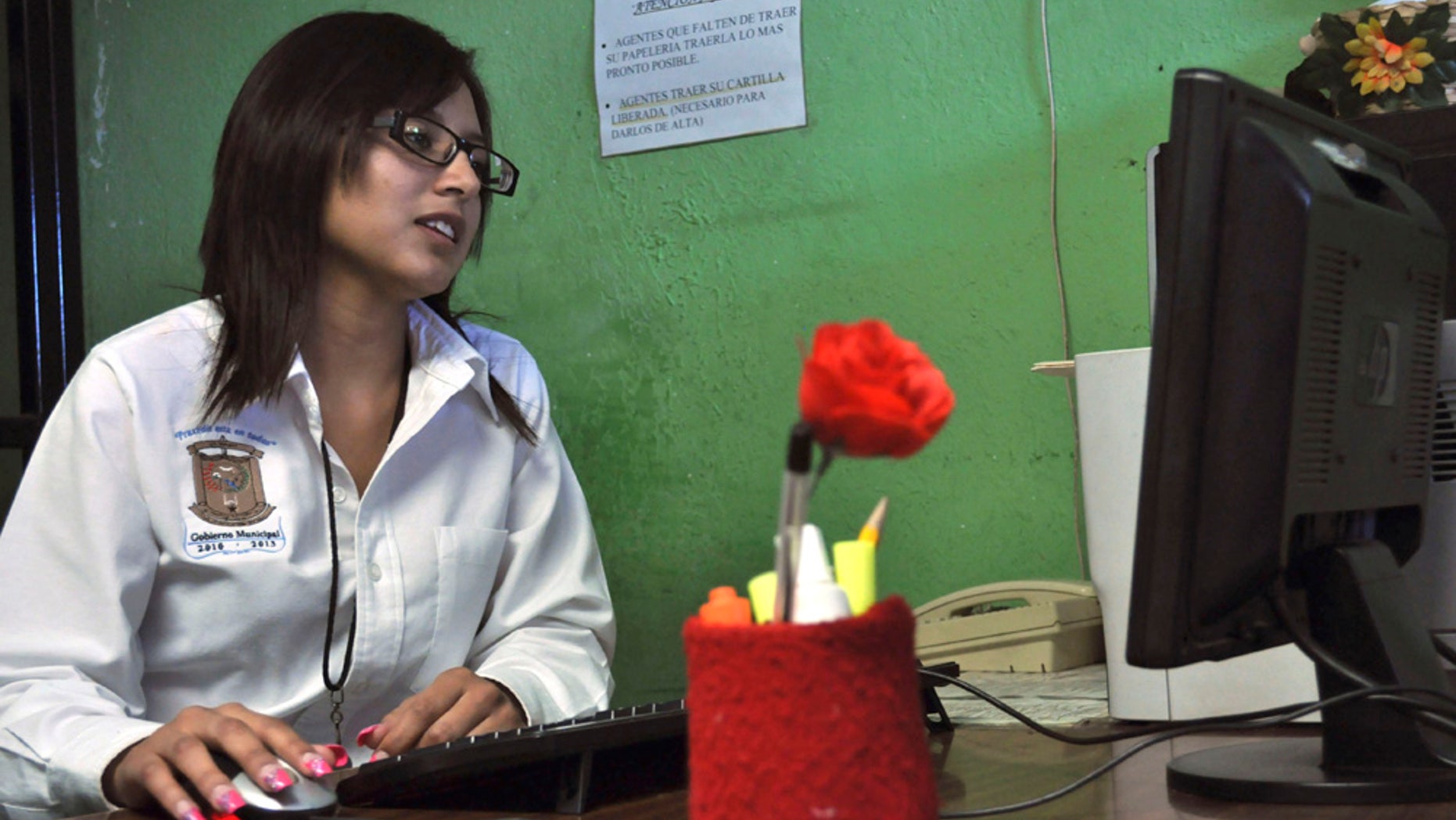 Twenty-year-old Marisol Valles Garcia sits at her desk after her swearing-in ceremony as the new police chief of the border town of Praxedis G. Guerrero, near Ciudad Juarez, Mexico, Wednesday, Oct. 20, 2010. Praxedis G. Guerrero was once a quiet farming town until two rival gangs, the Juarez and the Sinaloa drug cartels, began battling for the control of its single highway. (AP Photo/Raymundo Ruiz)