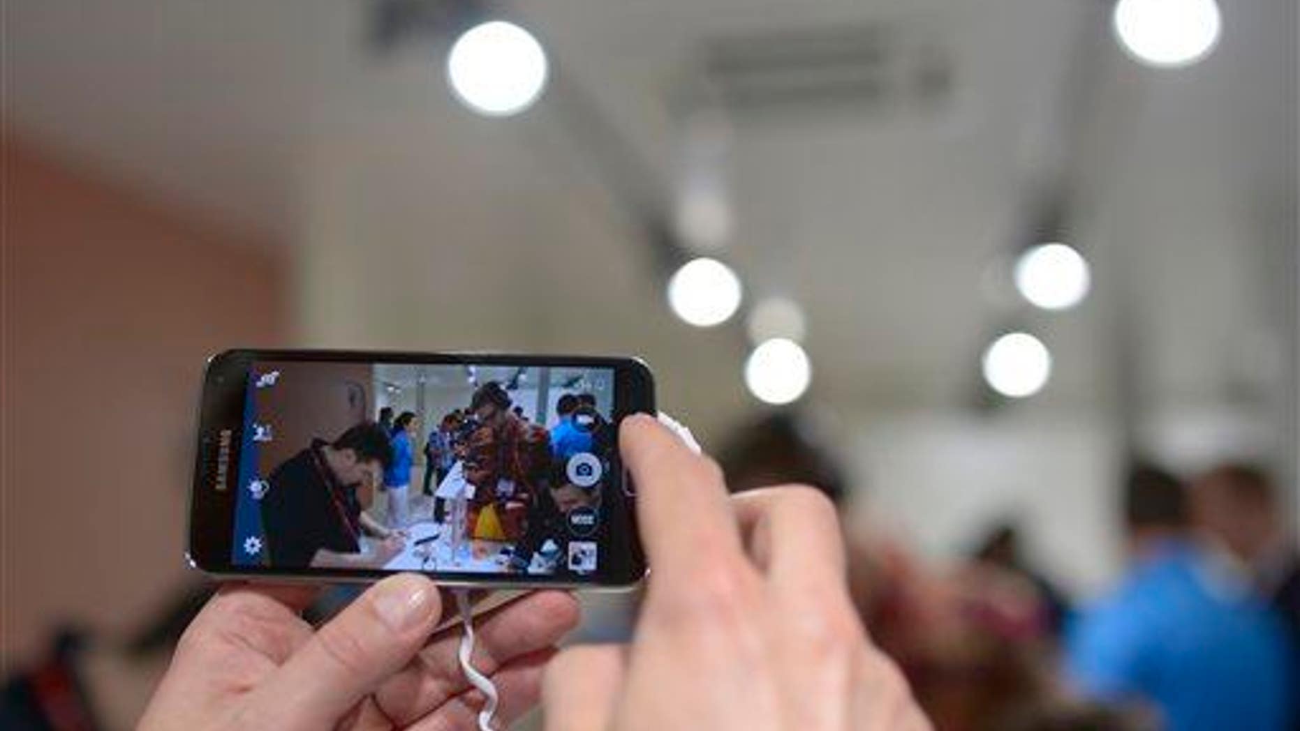In this Feb. 25, 2014 file photo, the new Samsung Galaxy S5 is displayed at the Mobile World Congress, the world's largest mobile phone trade show in Barcelona, Spain.