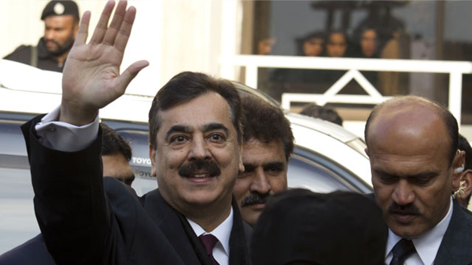 January 19, 2012: Pakistani Prime Minister Yousuf Raza Gilani waves upon his arrival at the Supreme Court in Islamabad.