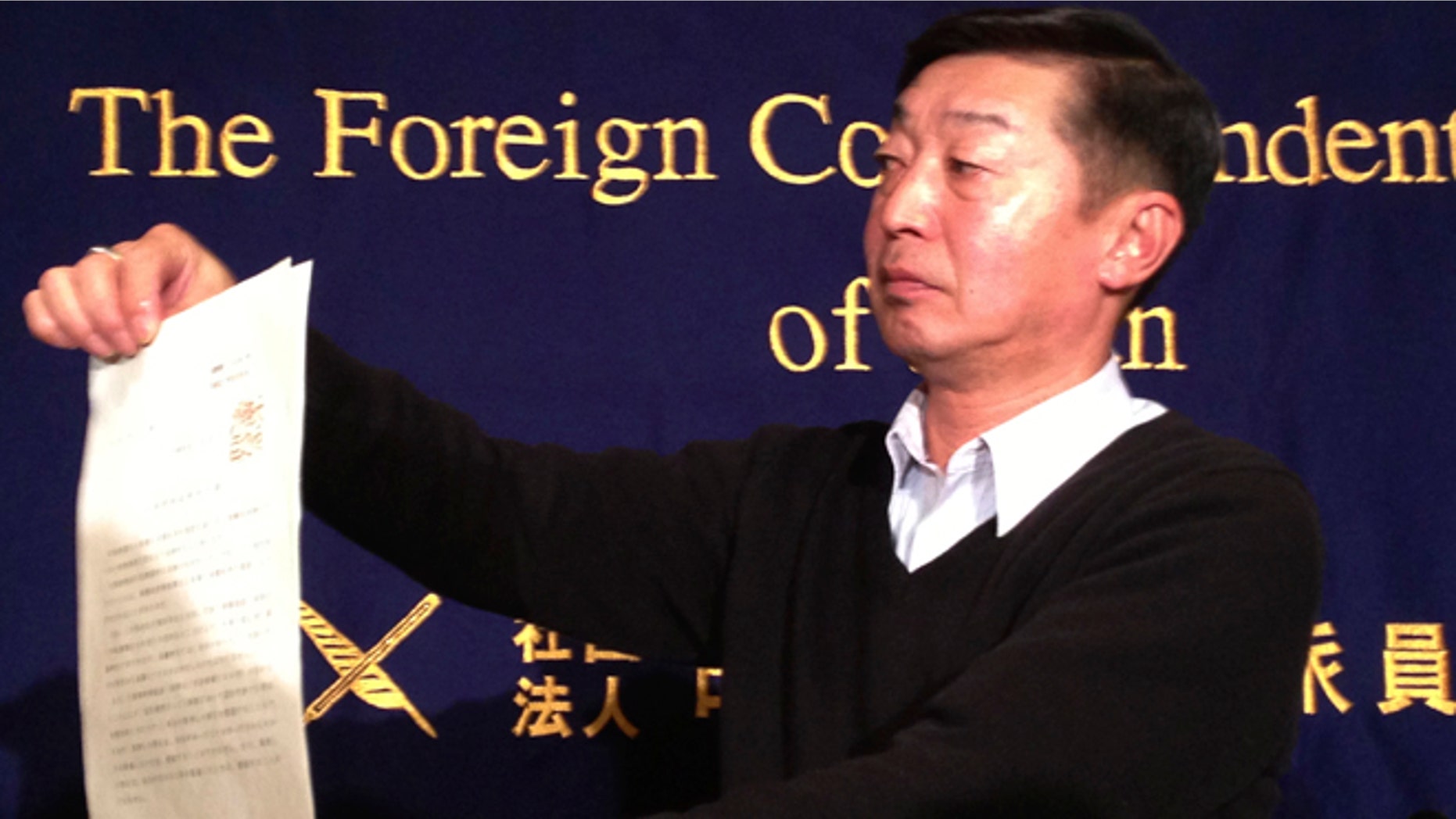 Feb. 12, 2015: Japanese freelance photographer Yuichi Sugimoto shows the press the original document of an order, signed by Foreign Minister Fumio Kishida, which he was given by Japanese foreign ministry officials at his home, during a news conference in Tokyo. Sugimoto said he was forced to give up his passport because he planned a reporting trip to Syria, which the government has stepped up warnings to its citizens not to visit after two Japanese were killed there in a recent hostage crisis.