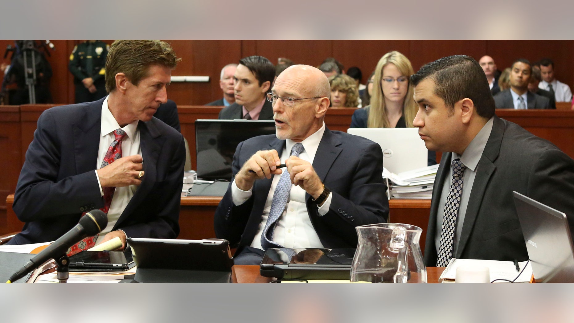 George Zimmerman listens to his defense counsel Mark O'Mara, left, and Don West, center during his trial in Sanford, Fla. July 10, 2013.