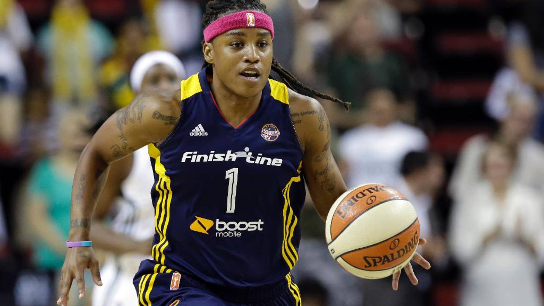 FILE - In this July 31, 2014, file photo, Indiana Fever's Shavonte Zellous moves the ball against the Seattle Storm during a WNBA basketball game in Seattle. After one of the most successful seasons in her career, leading Turkish power Galatasary to championships in both the domestic league and Euroleague, Zellous is now embroiled in a salary dispute. The club’s former president promised Zellous and her teammates that their bonuses would be doubled after Galatasary beat rival Fenerbahce. They’re still waiting for their money.(AP Photo/Elaine Thompson, File)