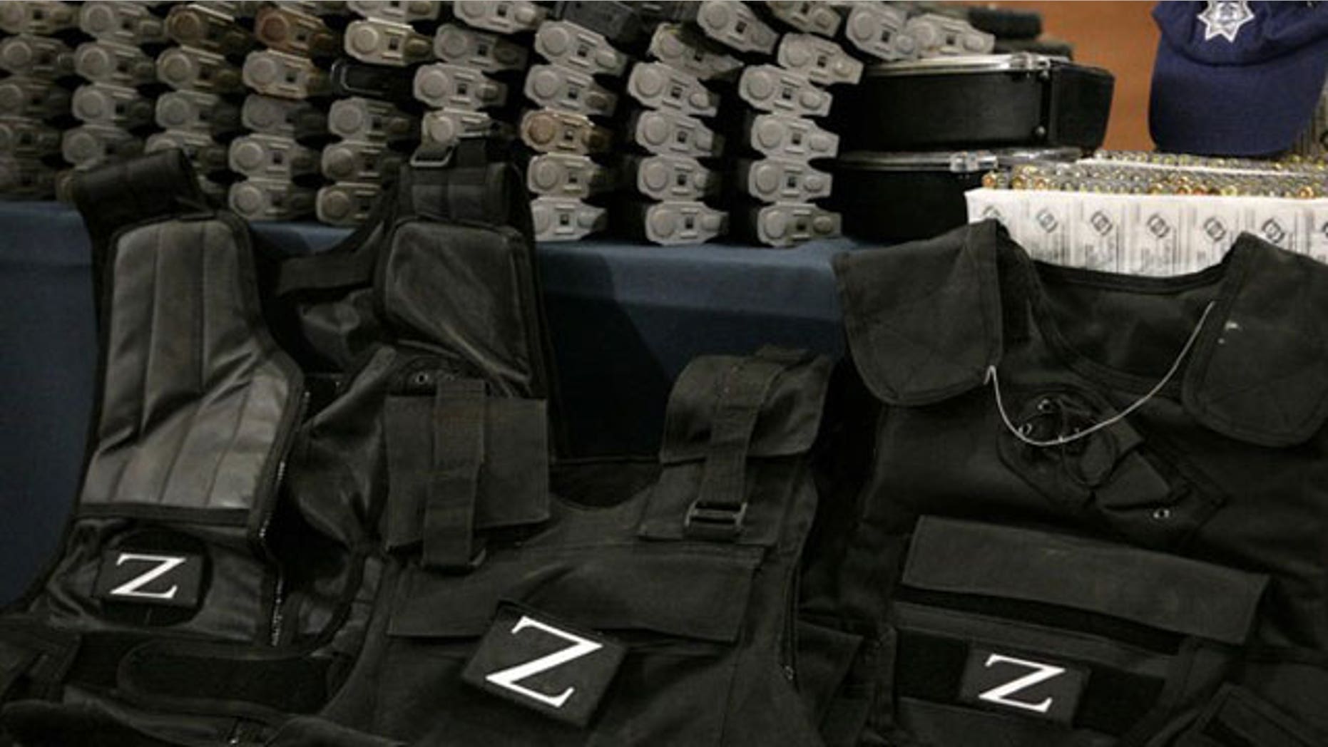 December 13, 2011: Flak jackets with the Zetas drug cartel's "Z" logo, cartridges and boxes with bullets are on display during a presentation to the media in Mexico City.